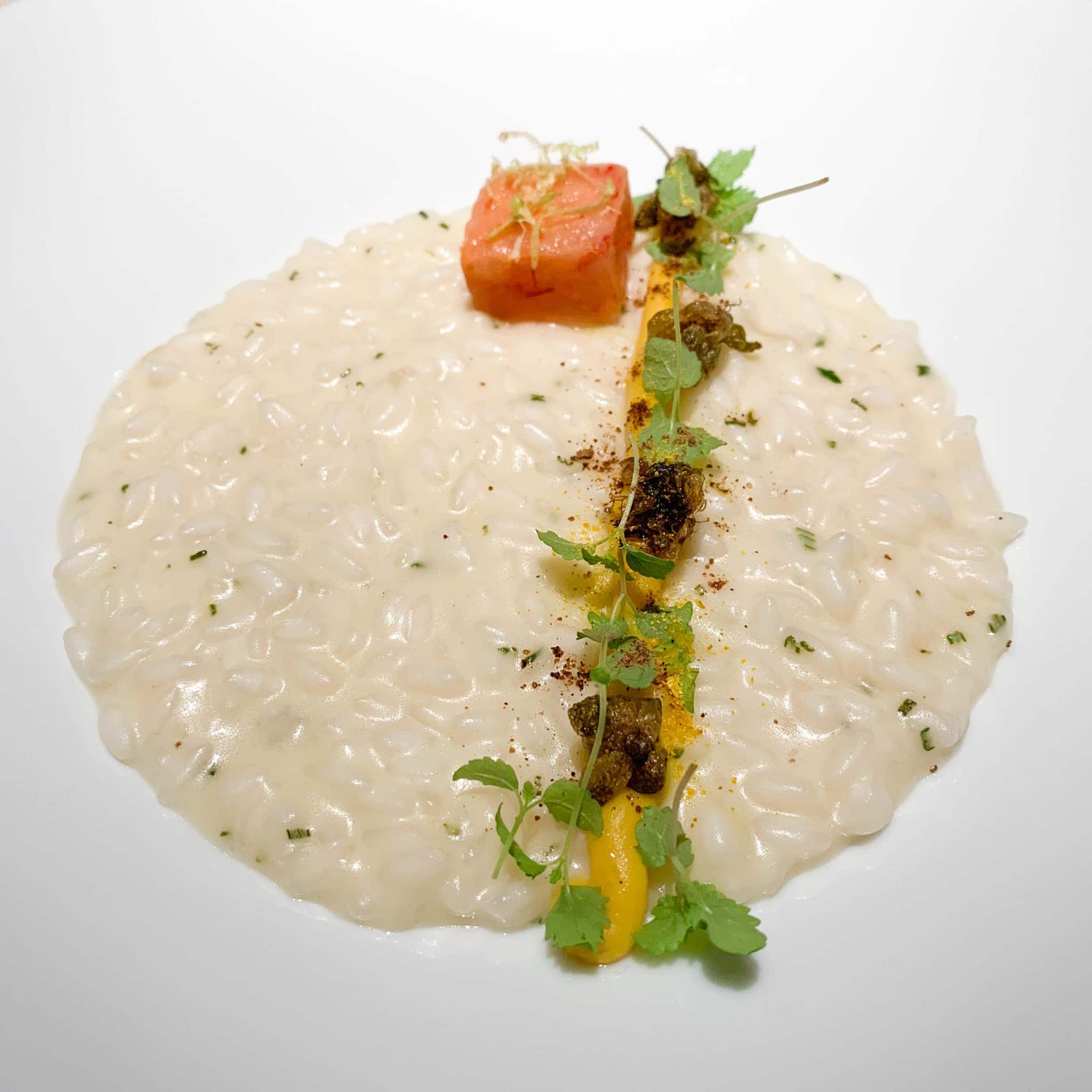 Lemon risotto with red prawns, rosemary, and capers