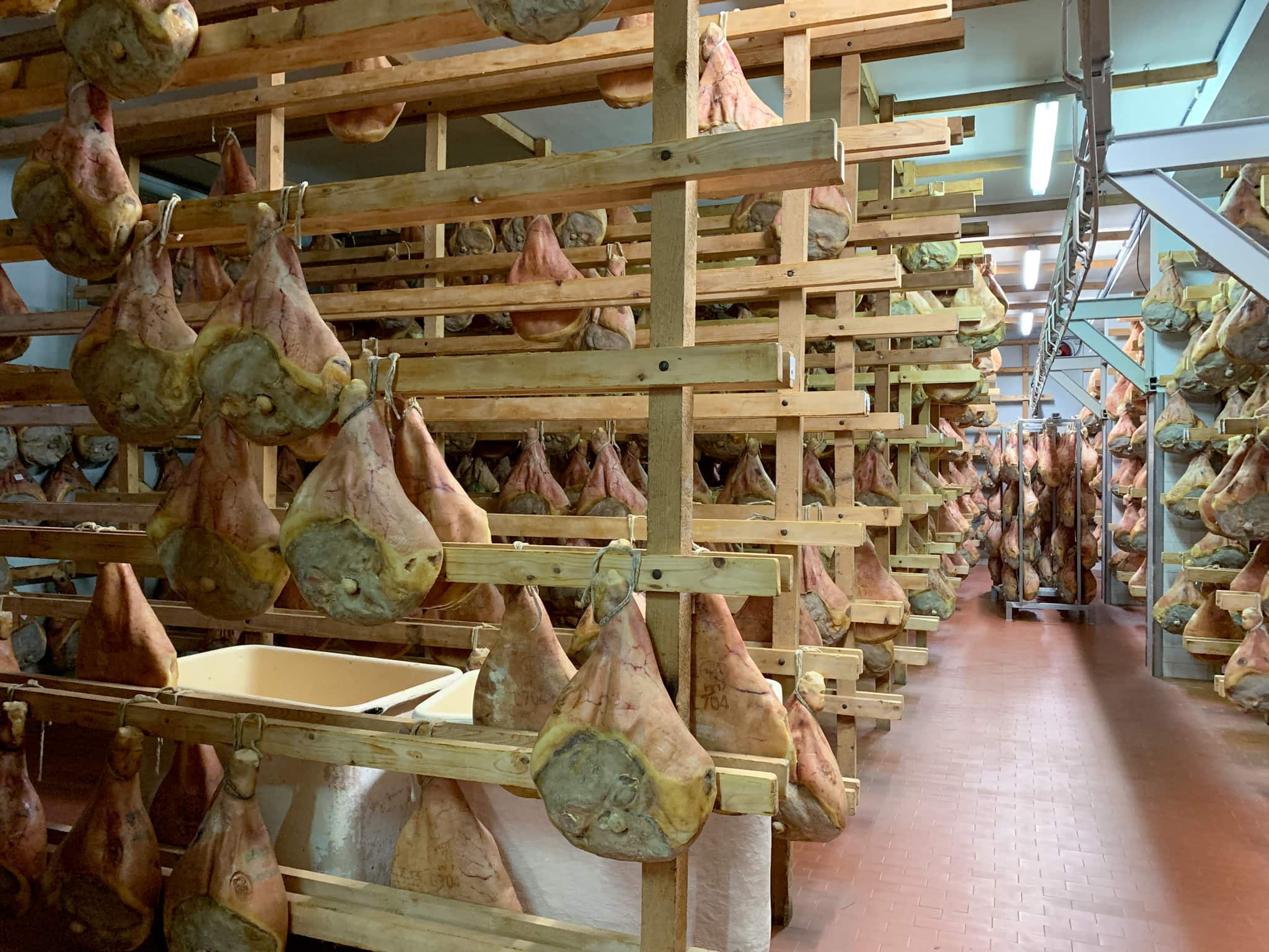 Prosciutto ages in a small factory in Emilia-Romagna, which we visited on our food and Ferrari tour.