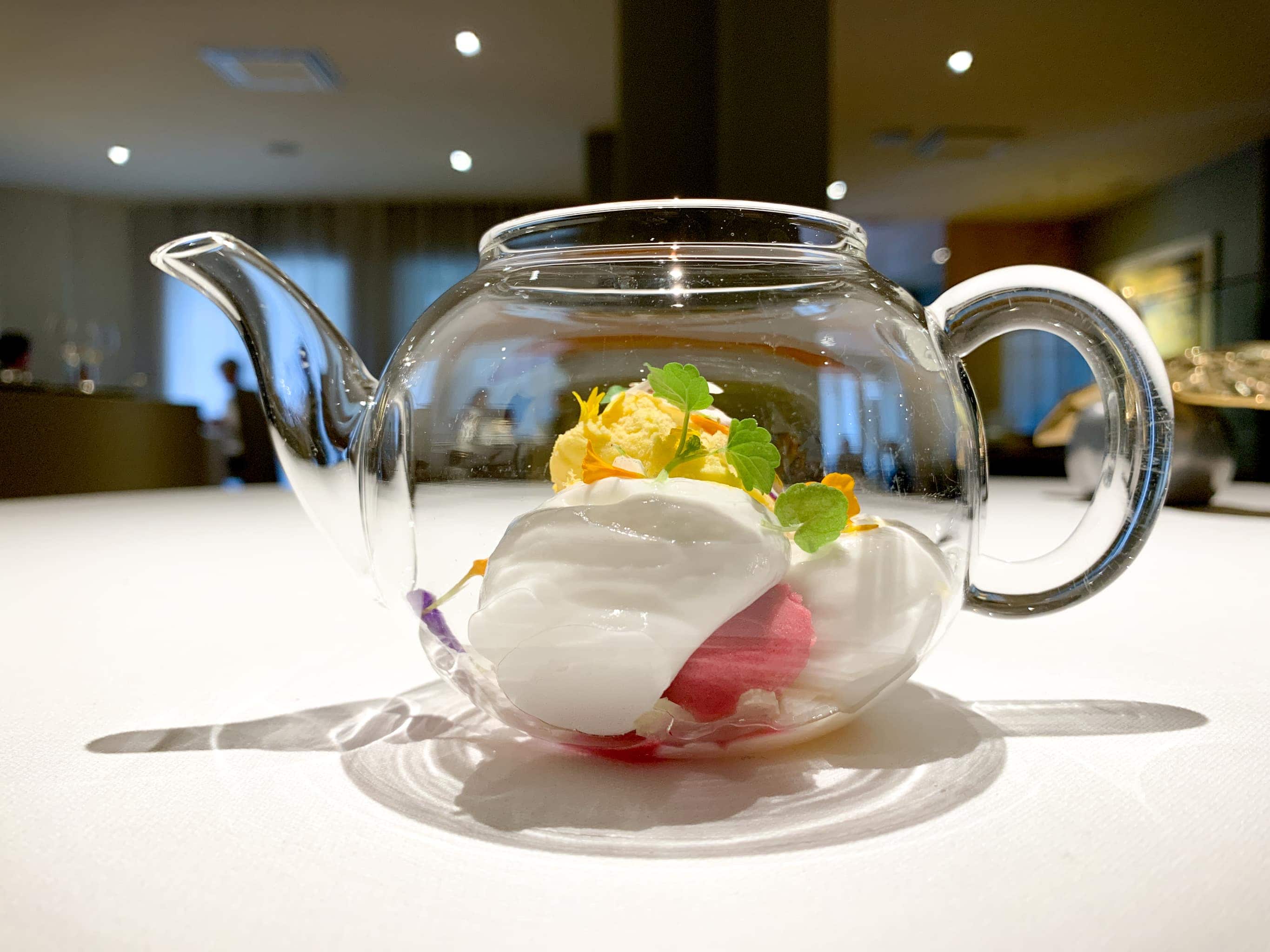 Floral tea dessert with "biscuit glace" of orange, yuzu, celery, and red tea and flowers ice cream