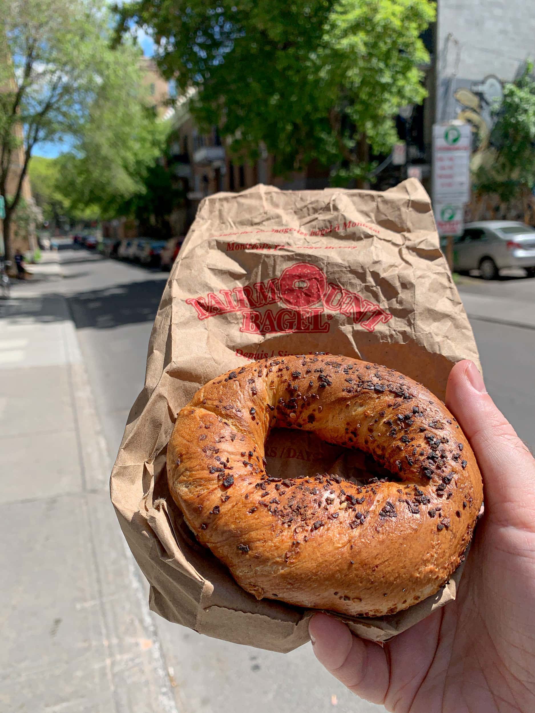 Preparing to eat a Fairmount Bagel in Montreal