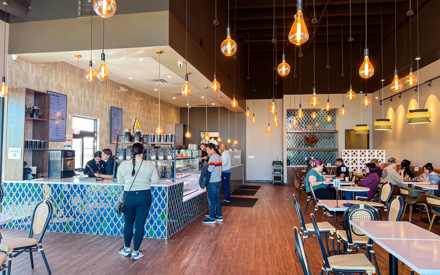Edison bulbs hang in Haraz Coffee House.