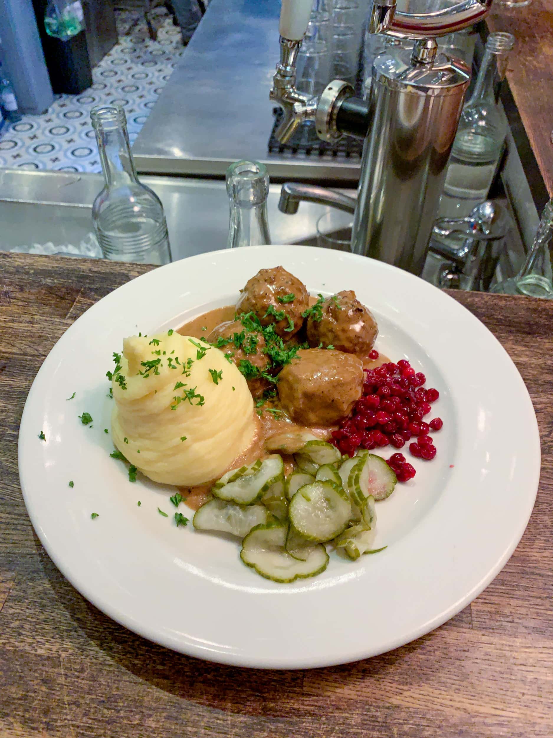Swedish meatballs, potato puree, lingonberries, and pickled cucumbers at Swedish Nomad Food & Bar. 