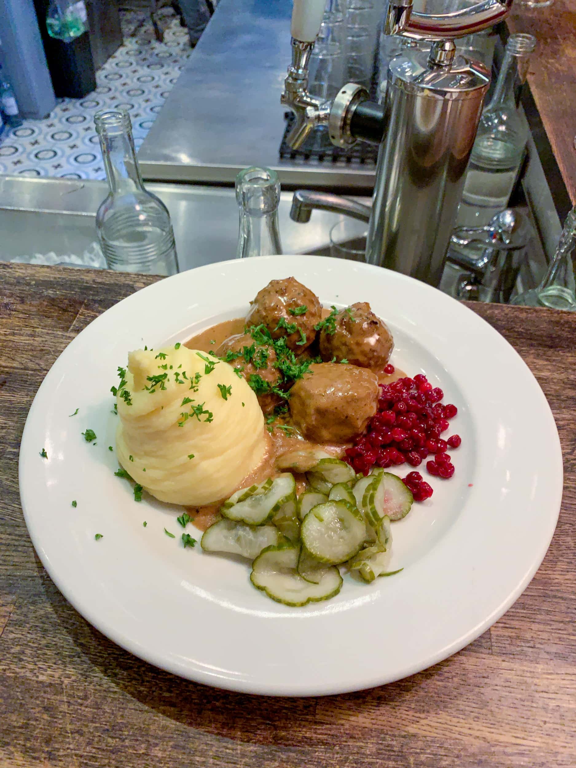 Swedish meatballs, potato puree, lingonberries, and pickled cucumbers