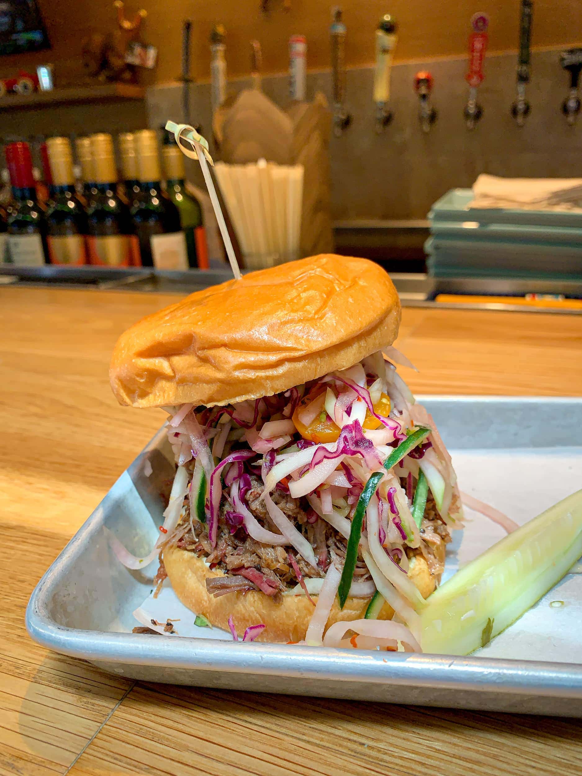 Oak smoked beef brisket with papaya salad, peanuts, chili aioli, and Thai herbs at Loro in Austin, TX