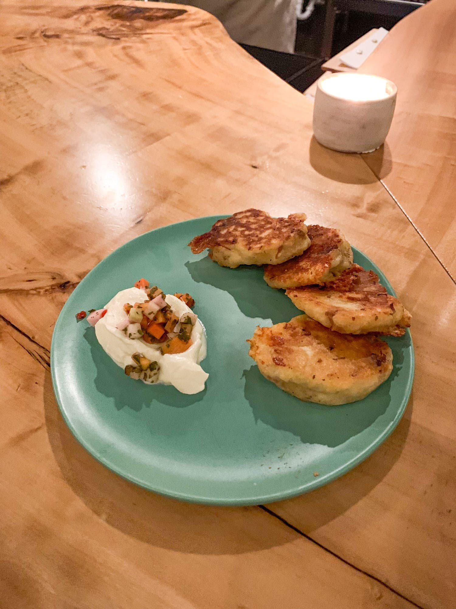 Yellow bolita Johnny Cakes with Texas Gold Cheddar, pork shoulder, and creme fraiche