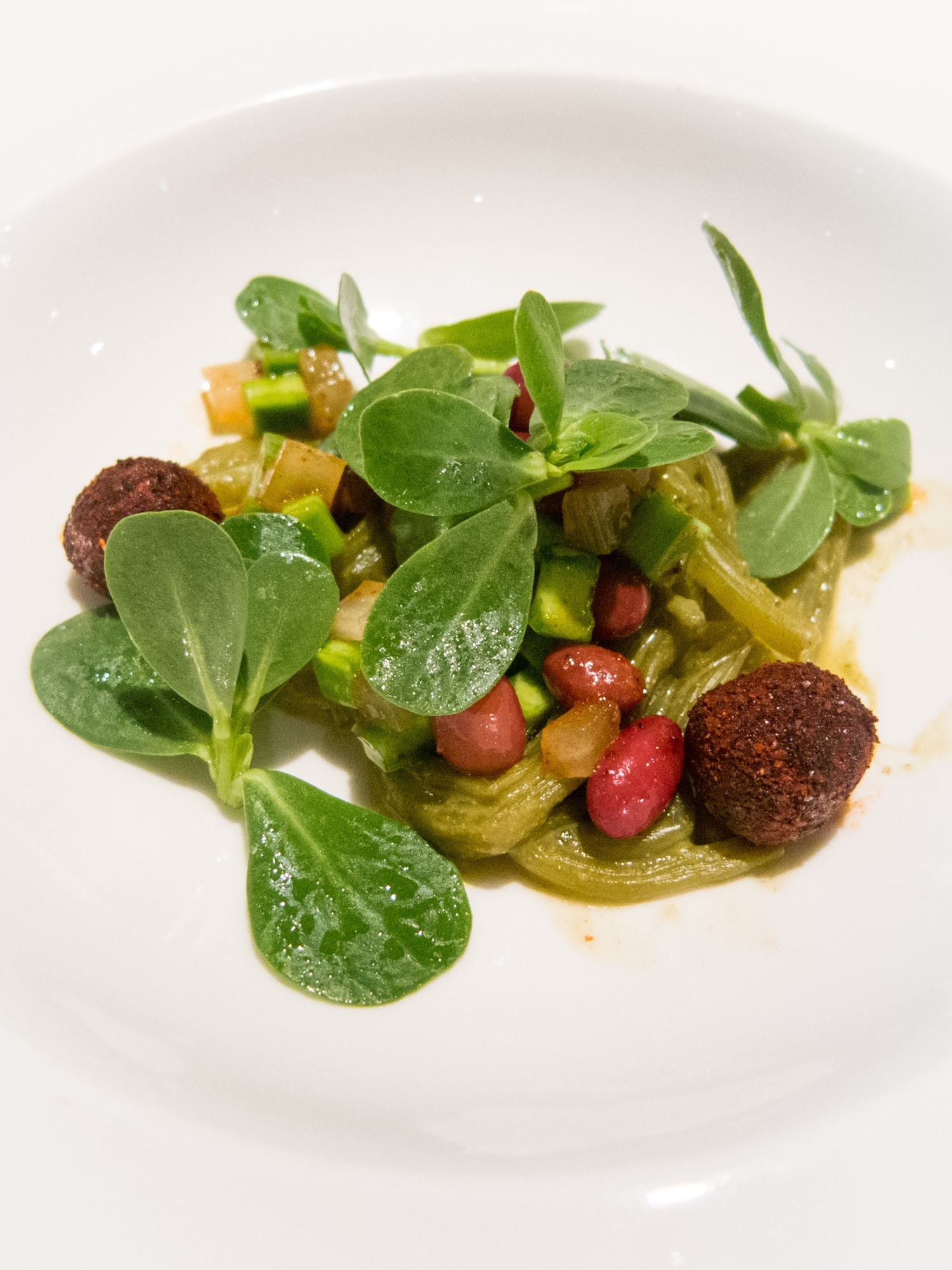 Purslane noodles, grilled onions, peppermint, and chile-covered balls of sheep cheese