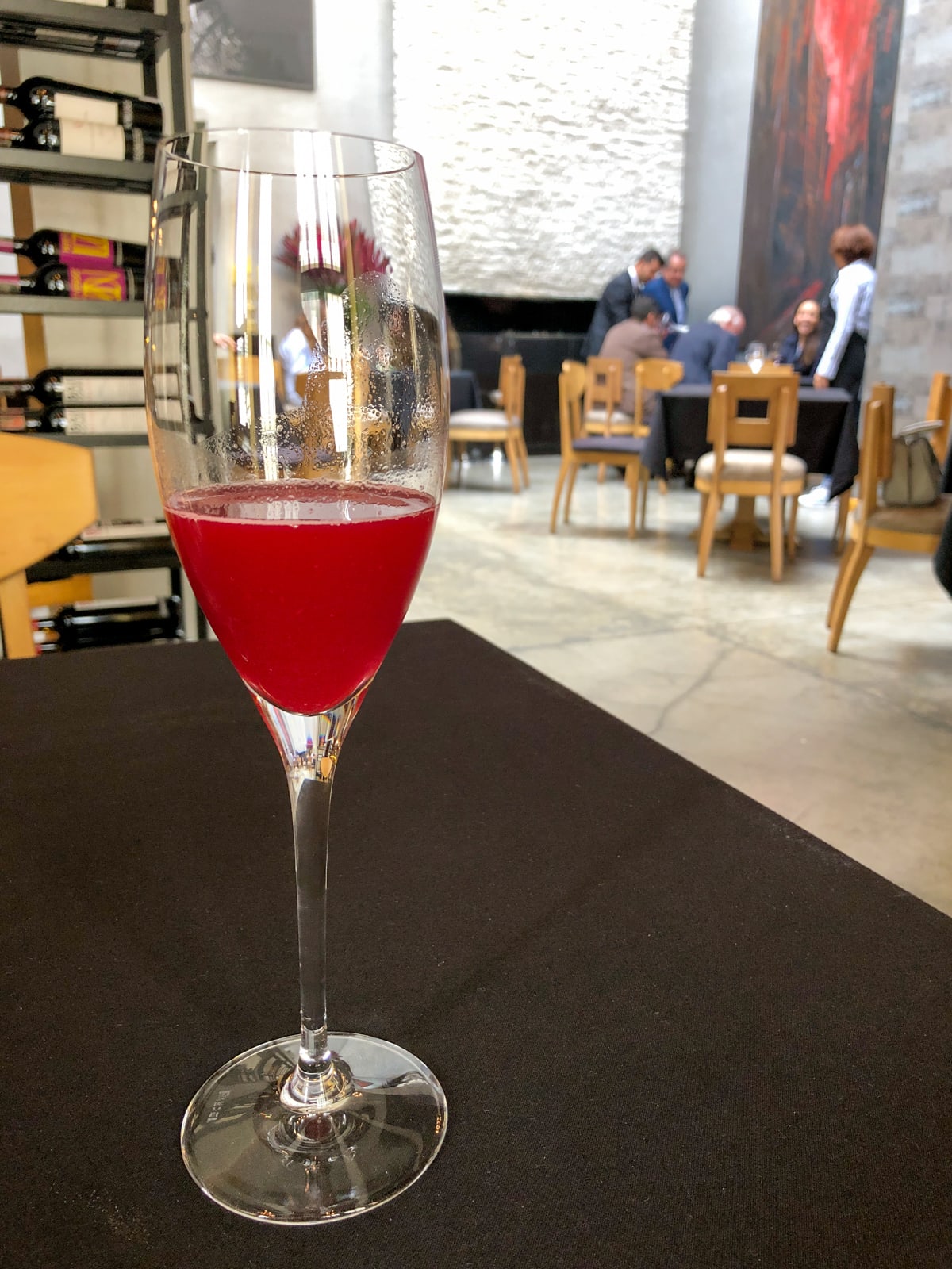 Fermented coca leaves drink. Chef Leonor Espinosa can be seen talking to guests in background.