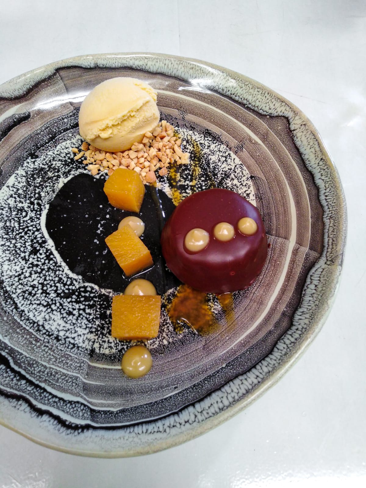 Macadamia nut financier in Colombian dark chocolate with honey and lavender ice cream, and rum pineapple at Carmen Restaurant in Medellín, Colombia