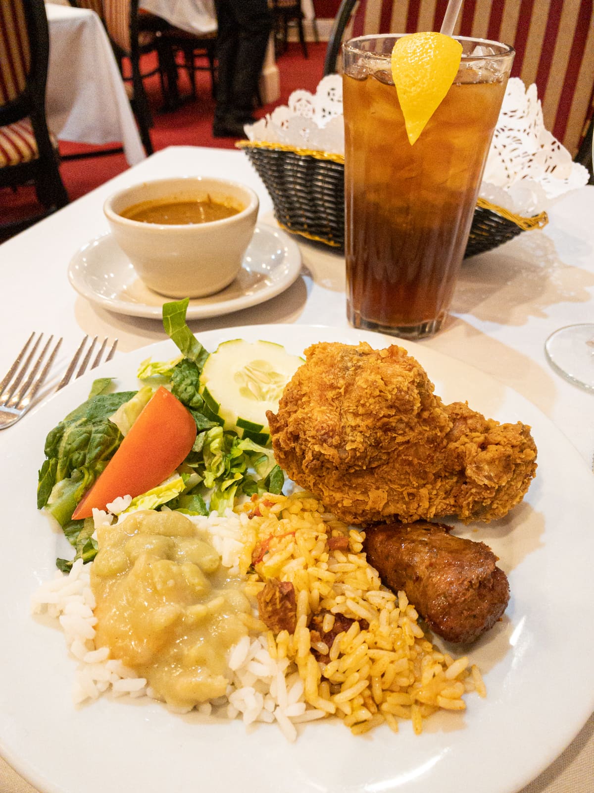 Fried chicken, rice and beans, salad, and unsweetened iced tea