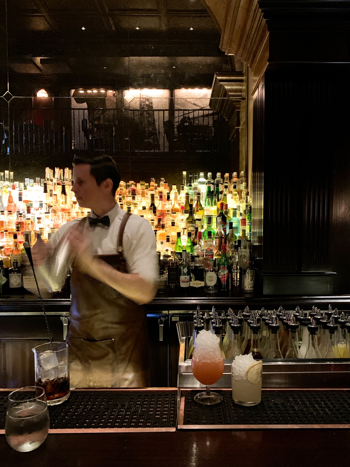 Mixing drinks at Nomad Bar in NYC