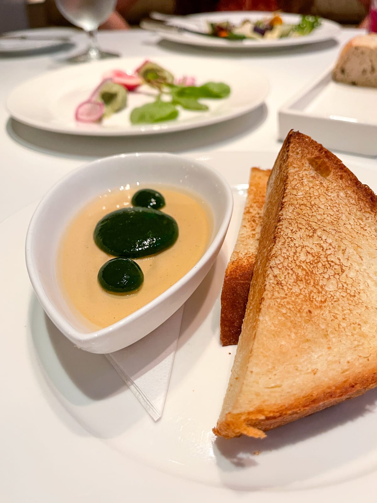 Foie gras mousse with Thai basil, white wine gelee, and sweet bread.