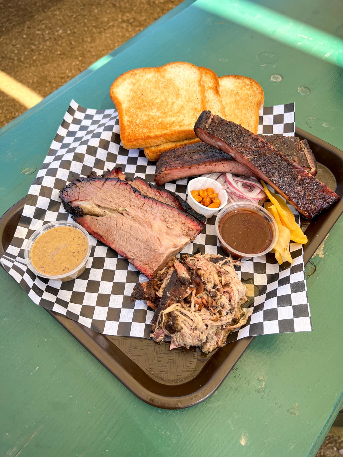 Brisket with smoked mustard butter, pulled pork, and pork spare ribs at Distant Relatives food truck