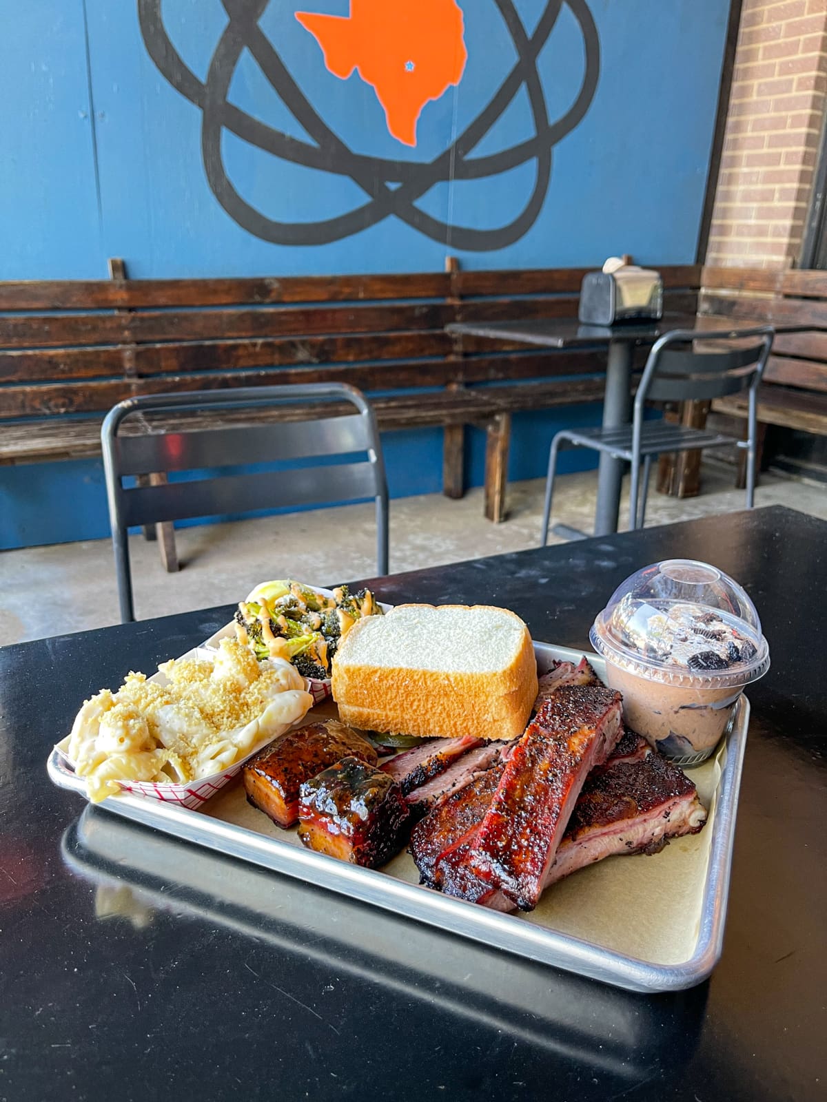 Brisket, pork belly and ribs, mac 'n cheese, broccoli, and Mexican chocolate rice pudding at InterStellar BBQ in North Austin, TX