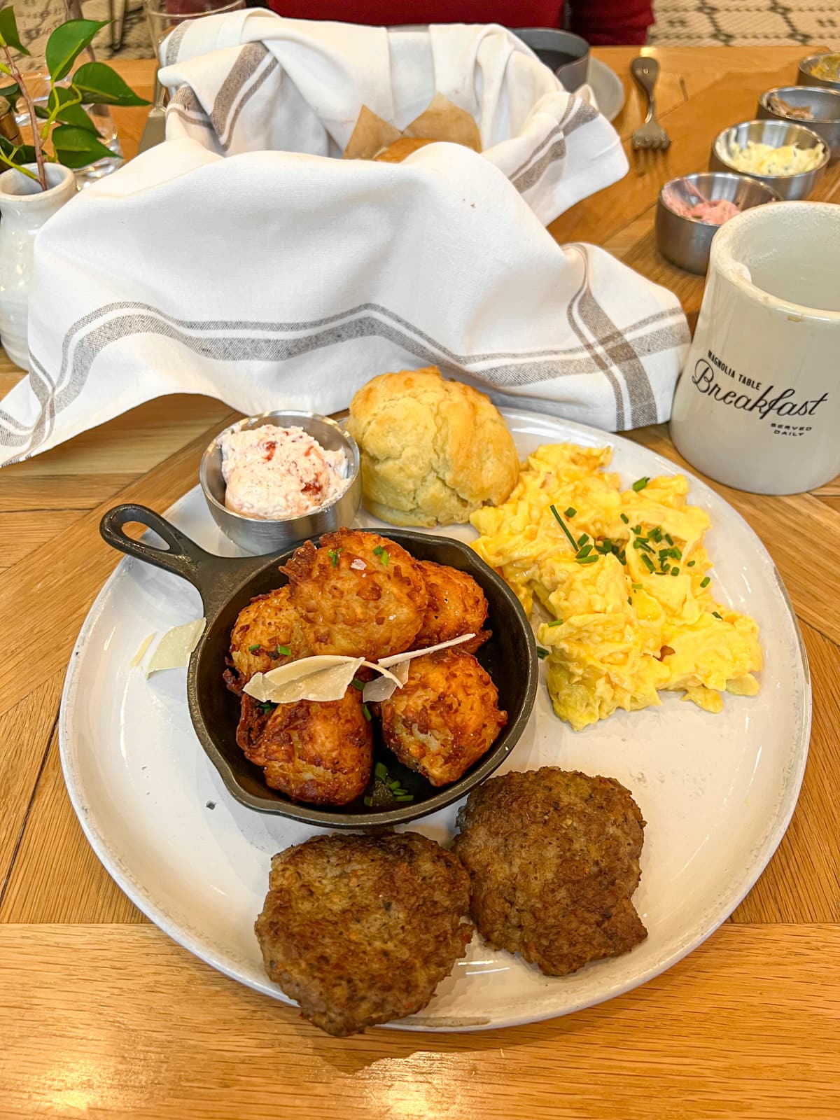 Farm breakfast with eggs, sausage, and tater tots at Magnolia Table in Waco, TX