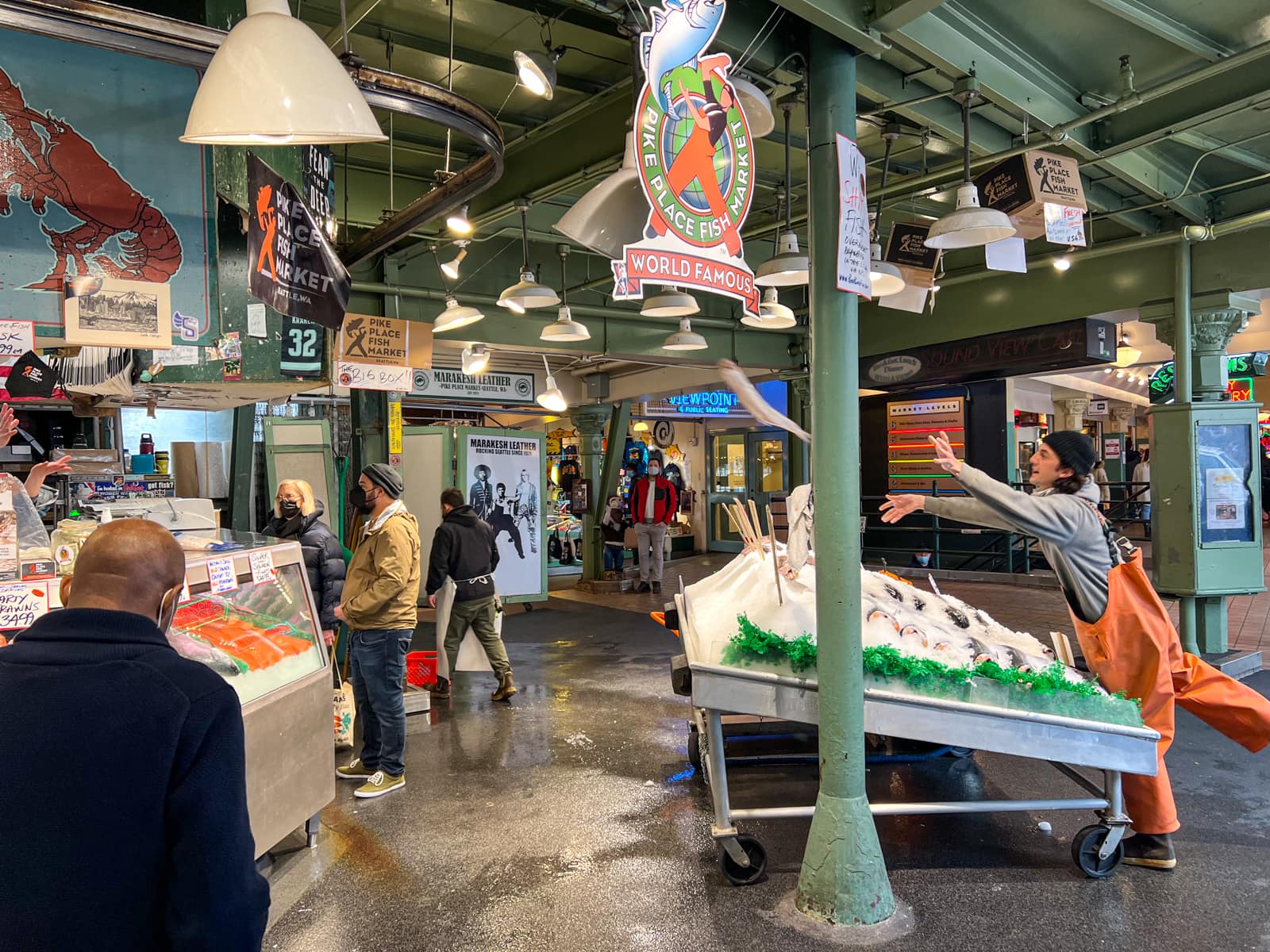 Man throwing a fish at the Pike Place Fish Market