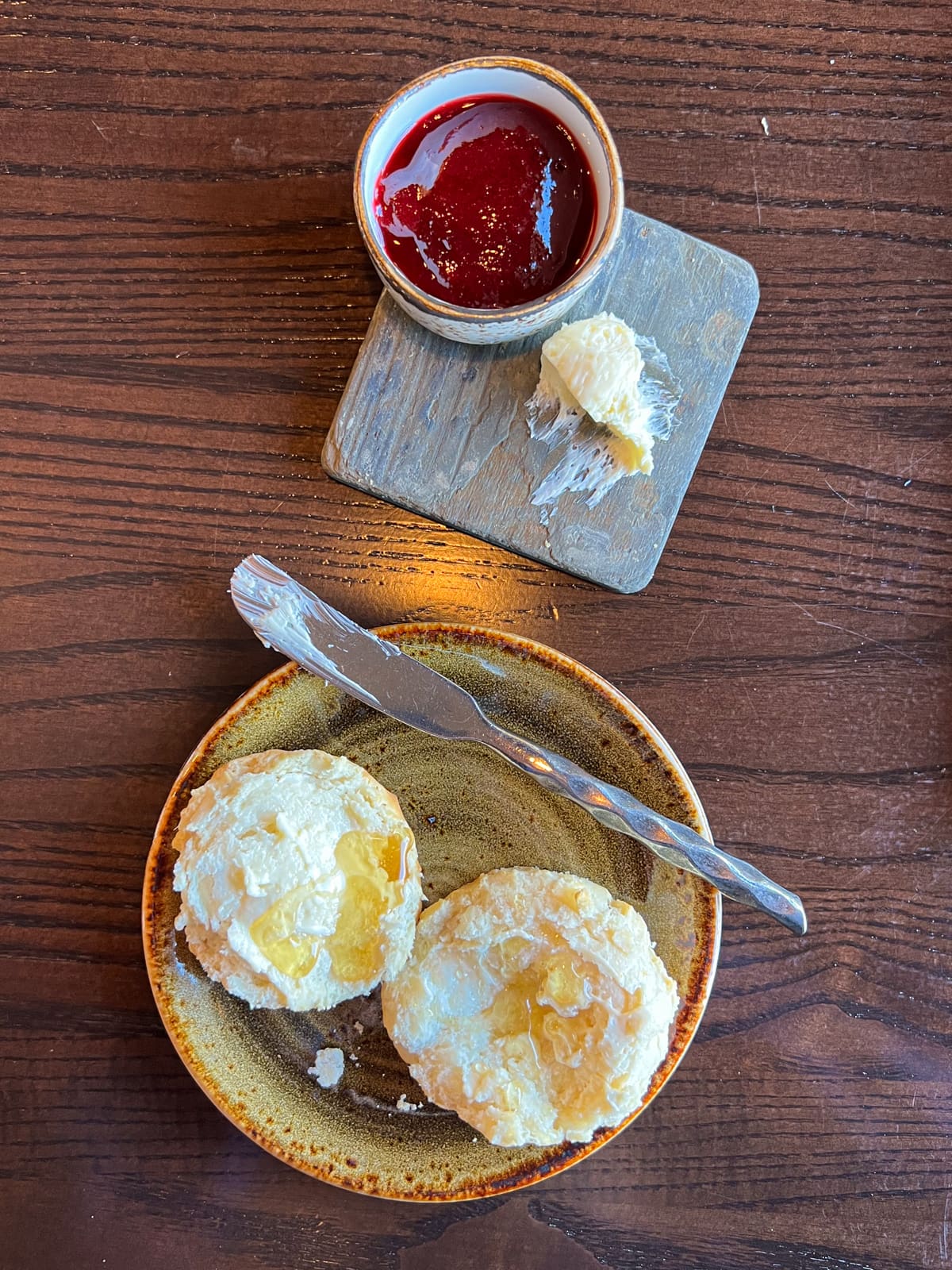 Buttered biscuit with honey, and a side of jam