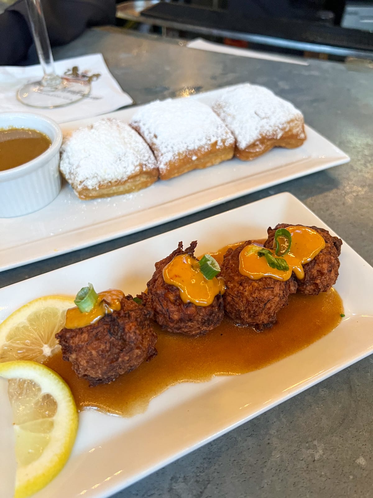 Blue crab and corn (near) and French Market-style beignets (far)