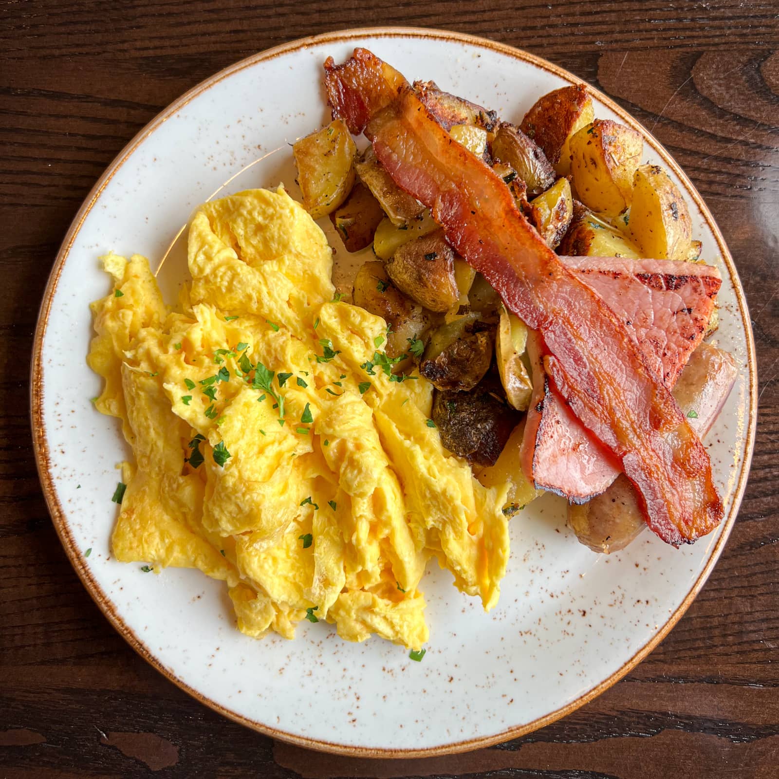 Salish Lodge country breakfast: Scrambled eggs, bacon, ham, apple pork sausage, and Yukon potatoes