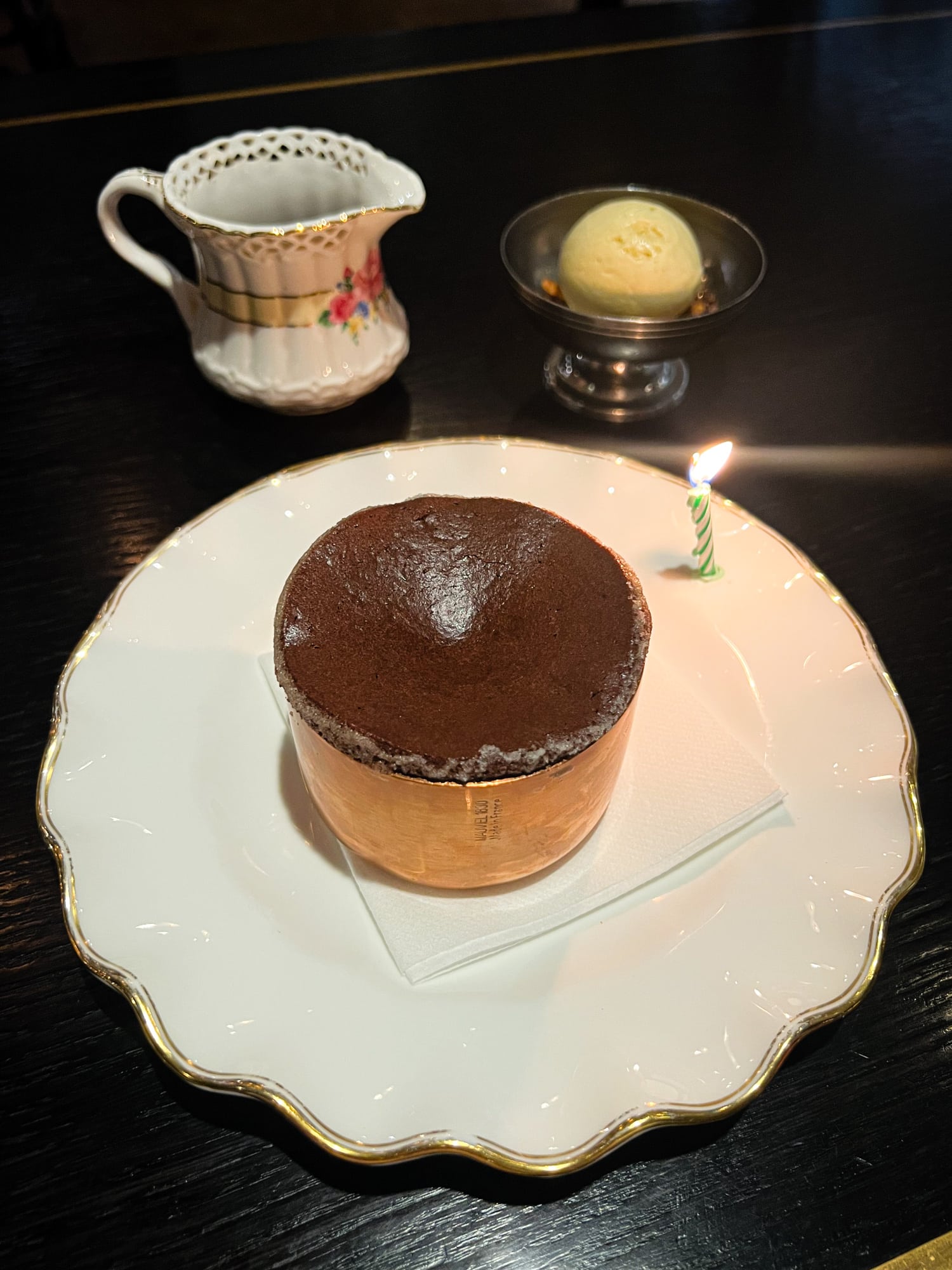 Chocolate soufflé, vanilla ice cream, and chocolate sauce