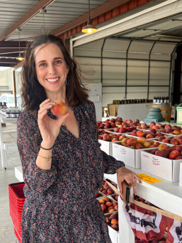 Kel with peaches at Eckhardt Orchards