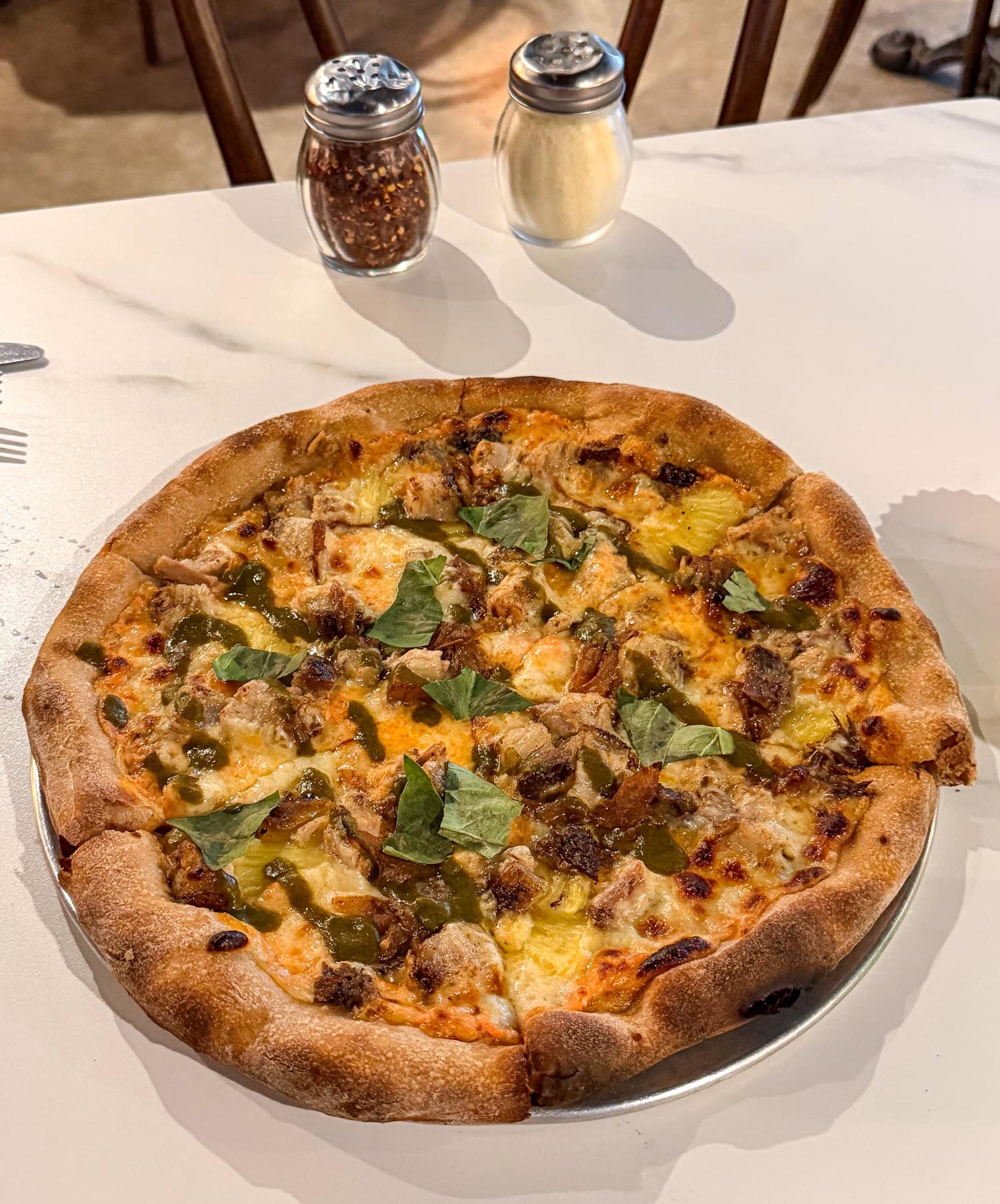 Pineapple Express pizza with jerk pork belly and pineapple at Prometheus Pizza Trattoria in Fredericksburg, Texas.