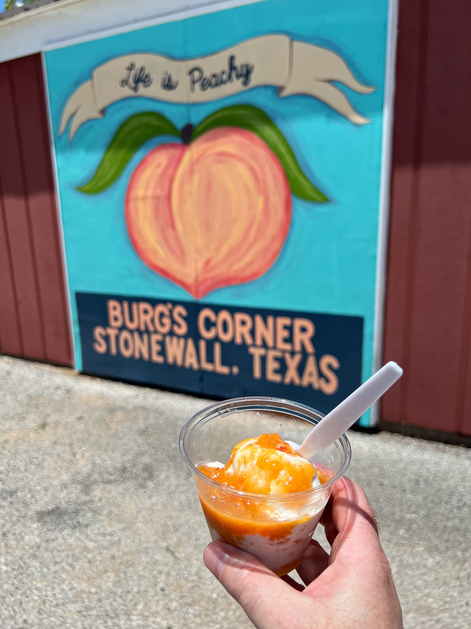 Peach ice cream with peach topping at Burg's Corner in Stonewall, Texas