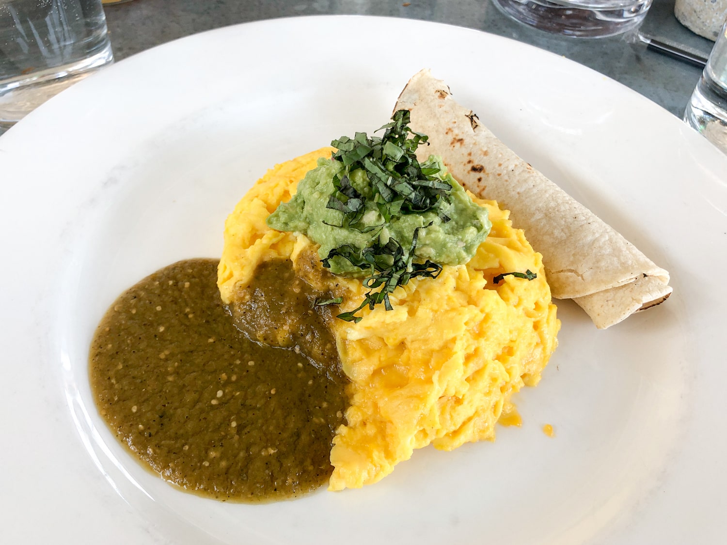 Cheddar eggs with green salsa and guacamole at Tiny Boxwood's in Central Austin