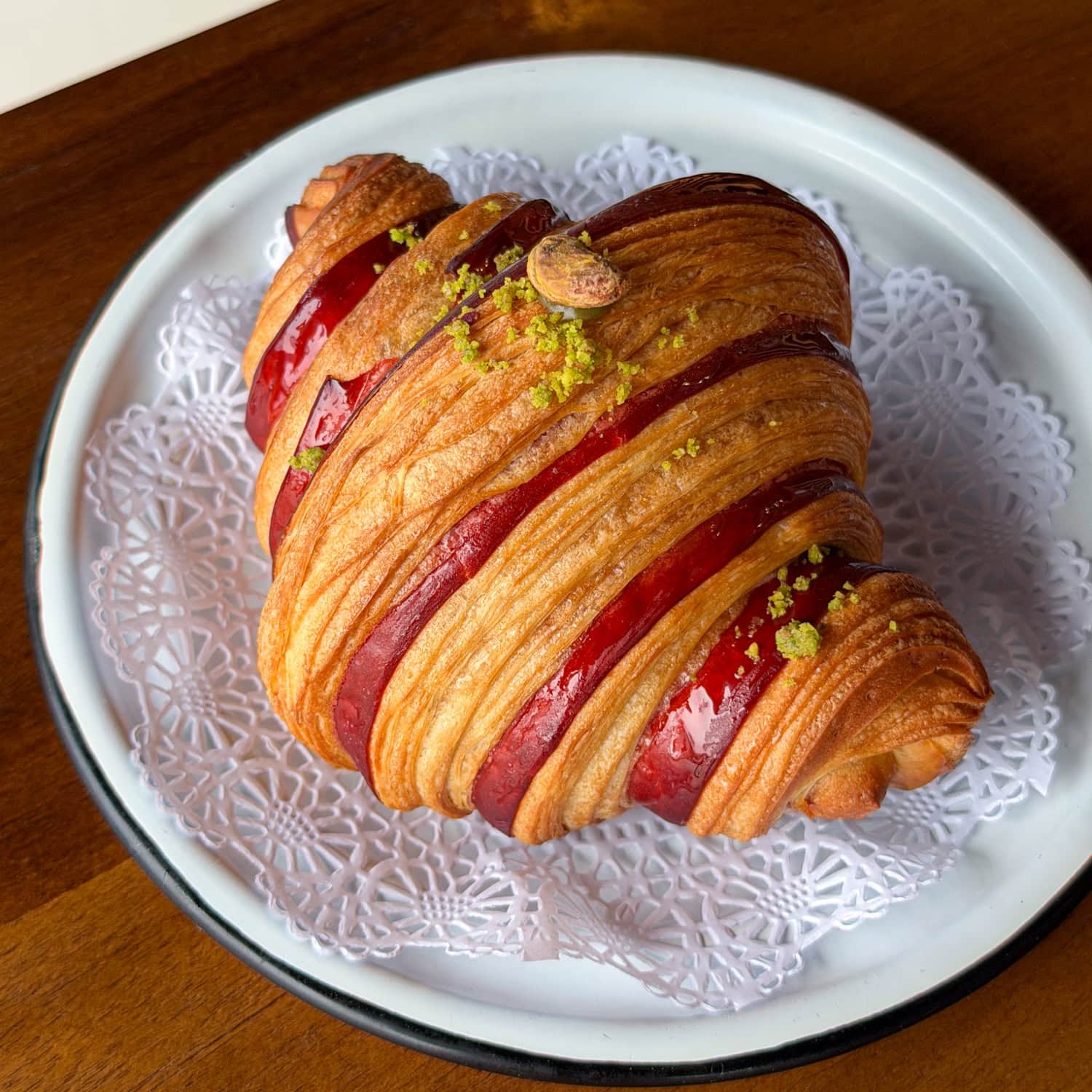 Cherry-pistachio croissant with red cherry filling and pistachio at Matok Bakery in Austin