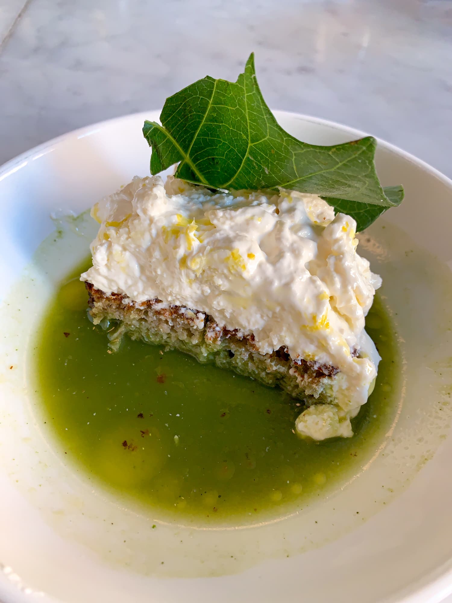 Burrata, green salsa, and charred bread at Estela in New York City