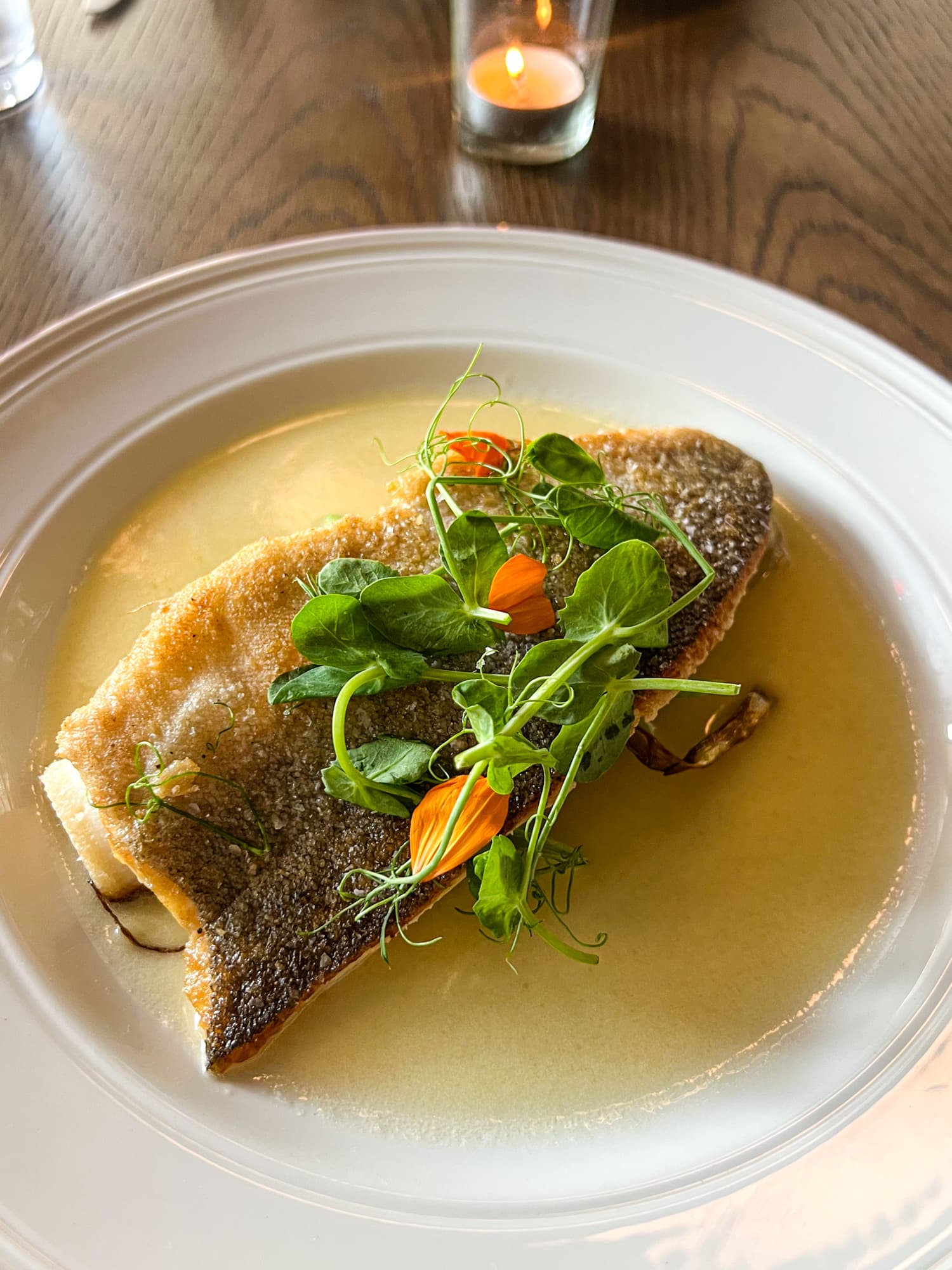 Pan-seared trout with brown butter, leeks, and pea vine