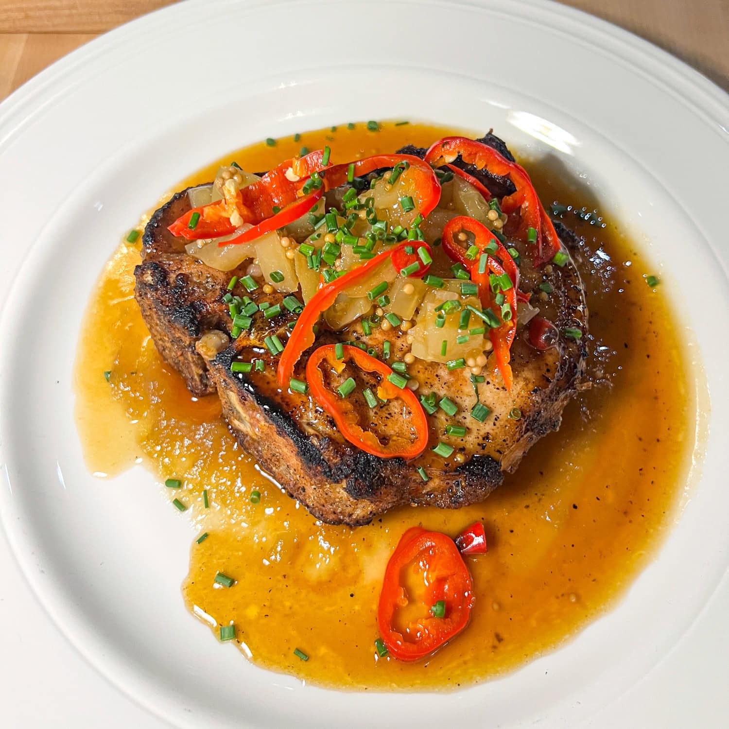 Dry-aged pork chop served with miso apple butter at The Butcher's Cellar.