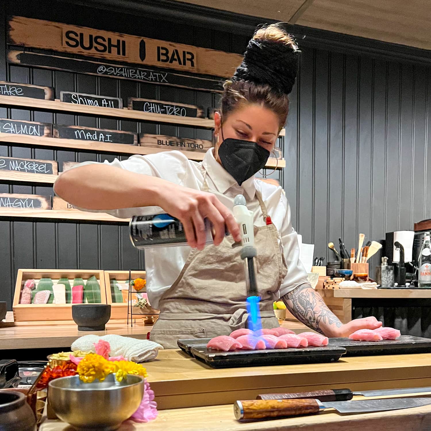 Chef Ambrely Ouimette torching tuna at SushiBar ATX, one of East Austin's best restaurants