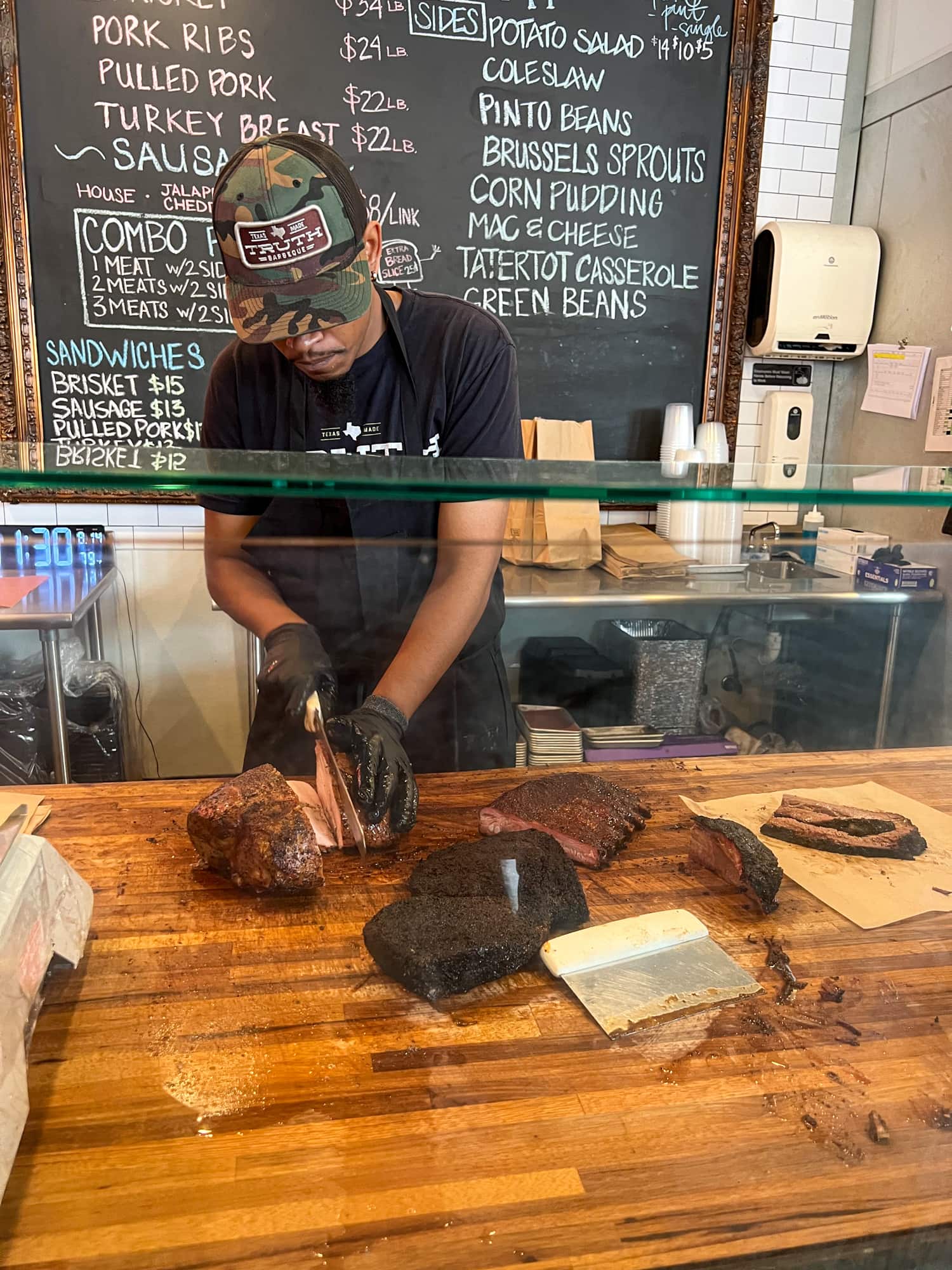 An employee at Truth BBQ in Houston slices brisket