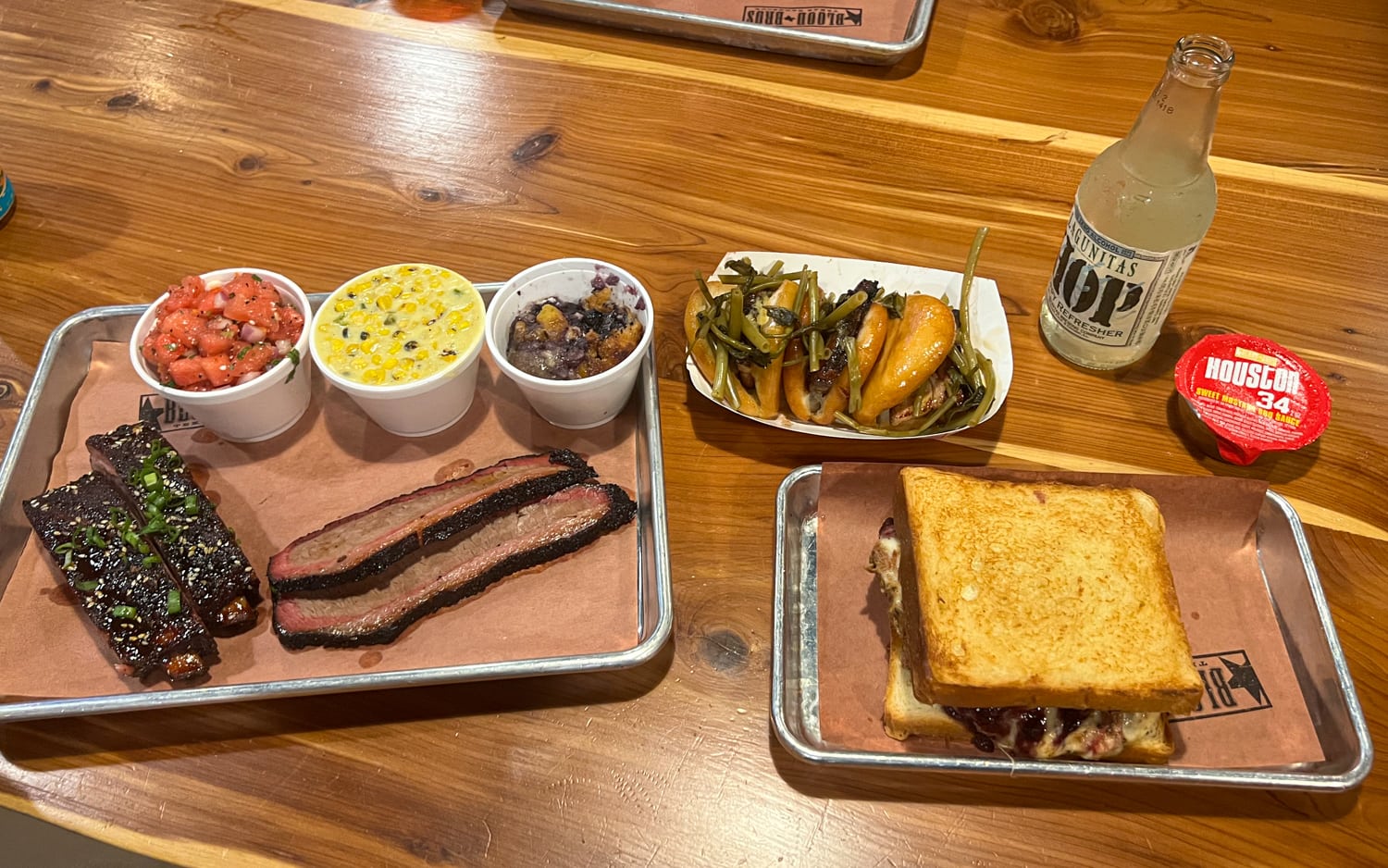 Brisket, ribs, Pig Moe sandwich, and pork belly bao at Blood Bros BBQ