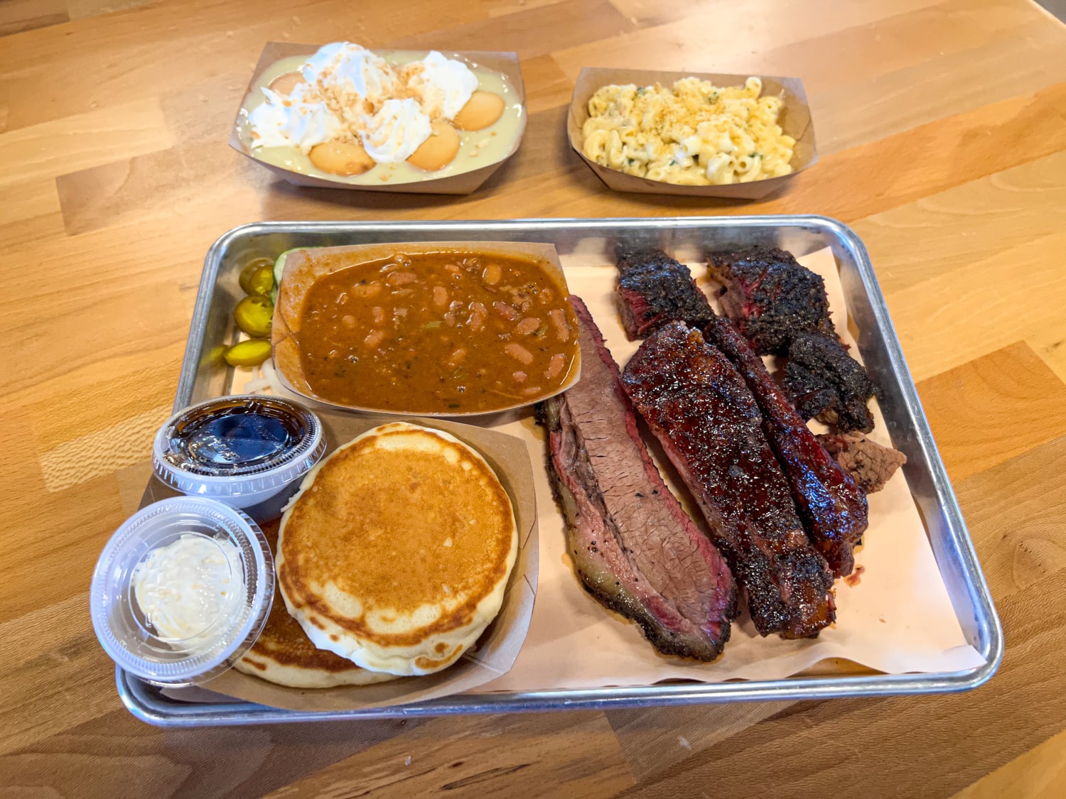 Brisket, ribs, pancakes with pulled pork, burnt end beans, mac 'n cheese, and banana pudding at Guess Family Barbecue in Waco, TX