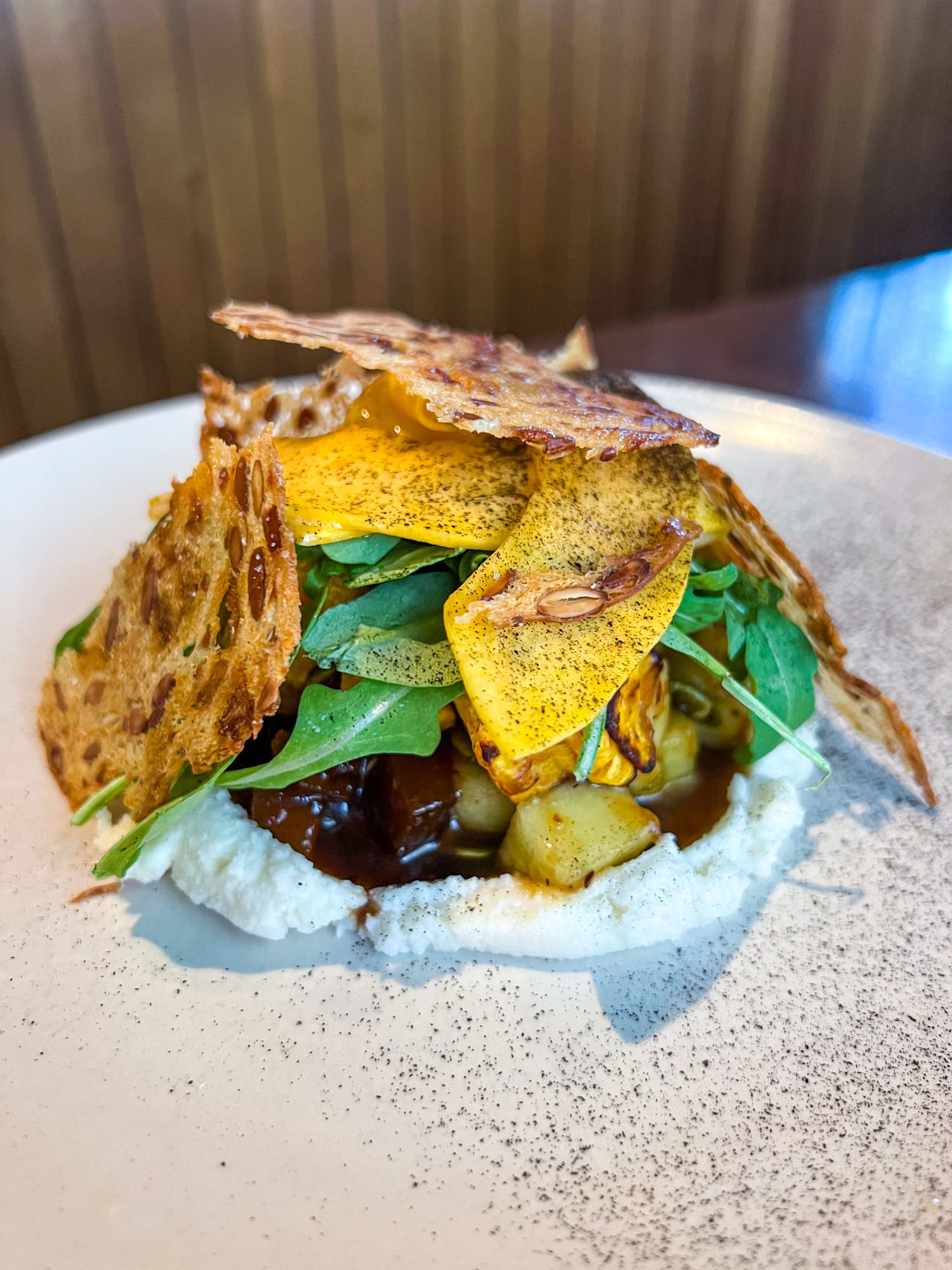 Butternut squash with raisin bread crisps, arugula, parmesan, and balsamic at Homewood, one of the best restaurants in Dallas, Texas