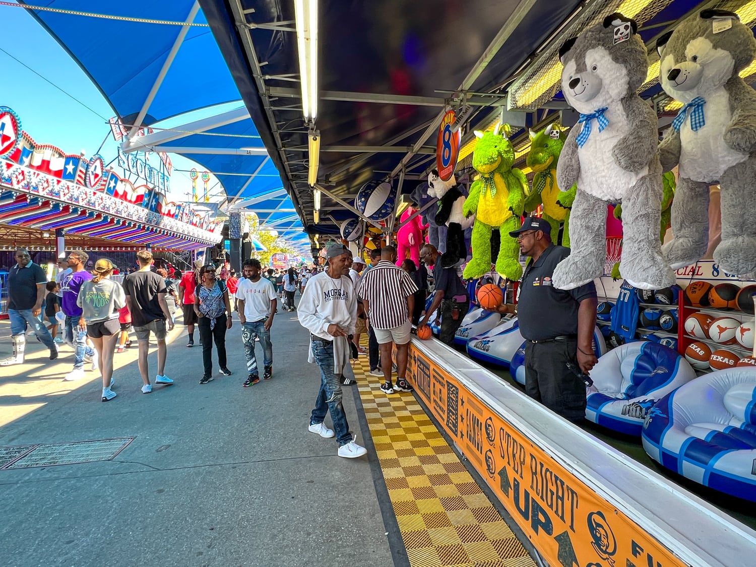 Walking through a gauntlet of Midway carnival games
