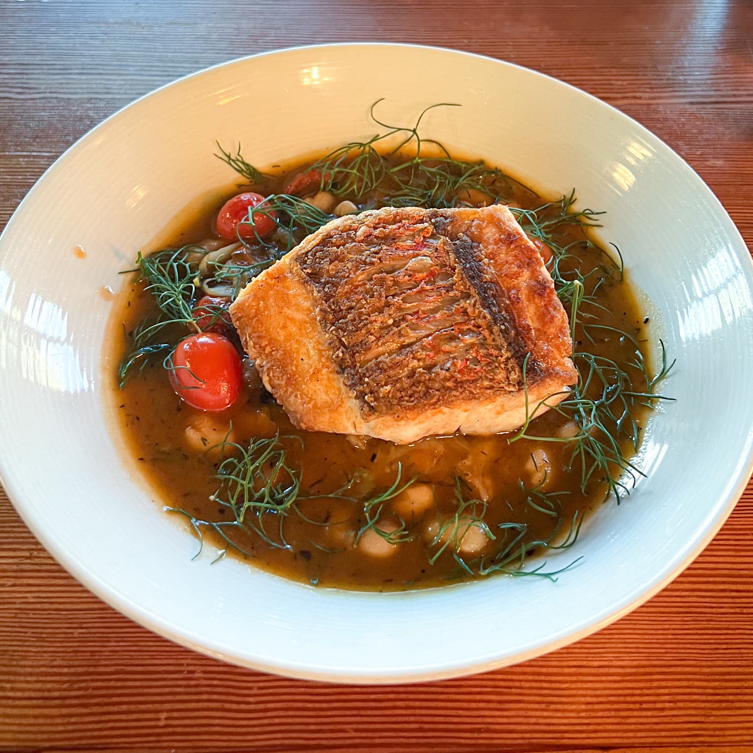 Pan-roasted Gulf fish with white beans and confit cherry tomatoes at Bywater American Bistro