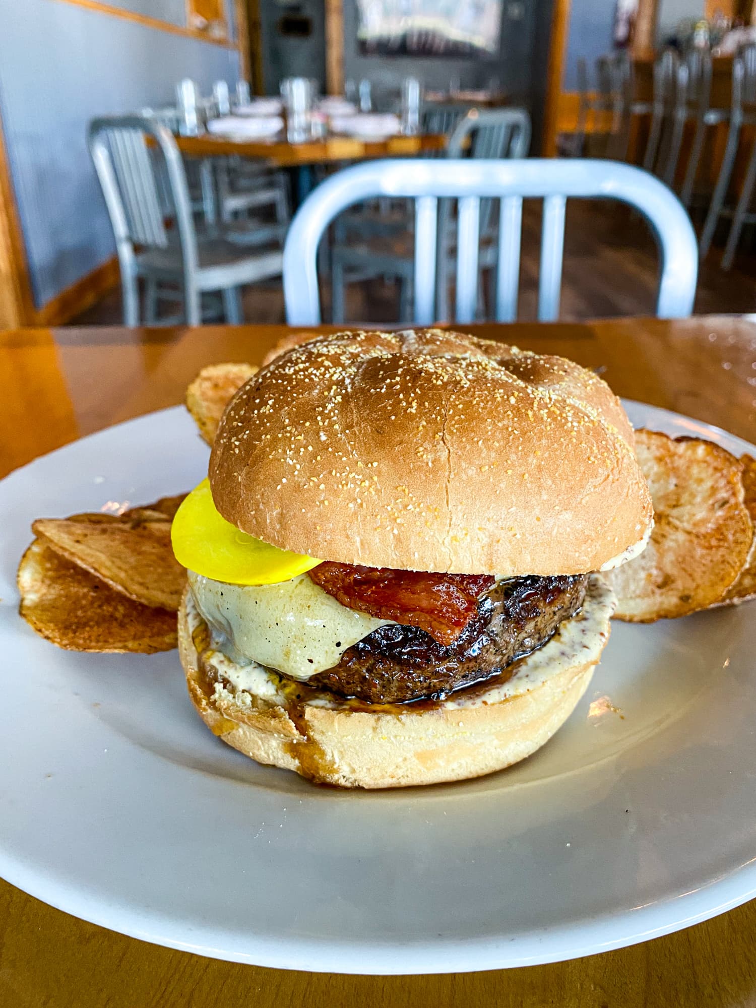 Toup's wagyu beef burger with pickled squash, cheddar cheese, bacon, and creole aioli