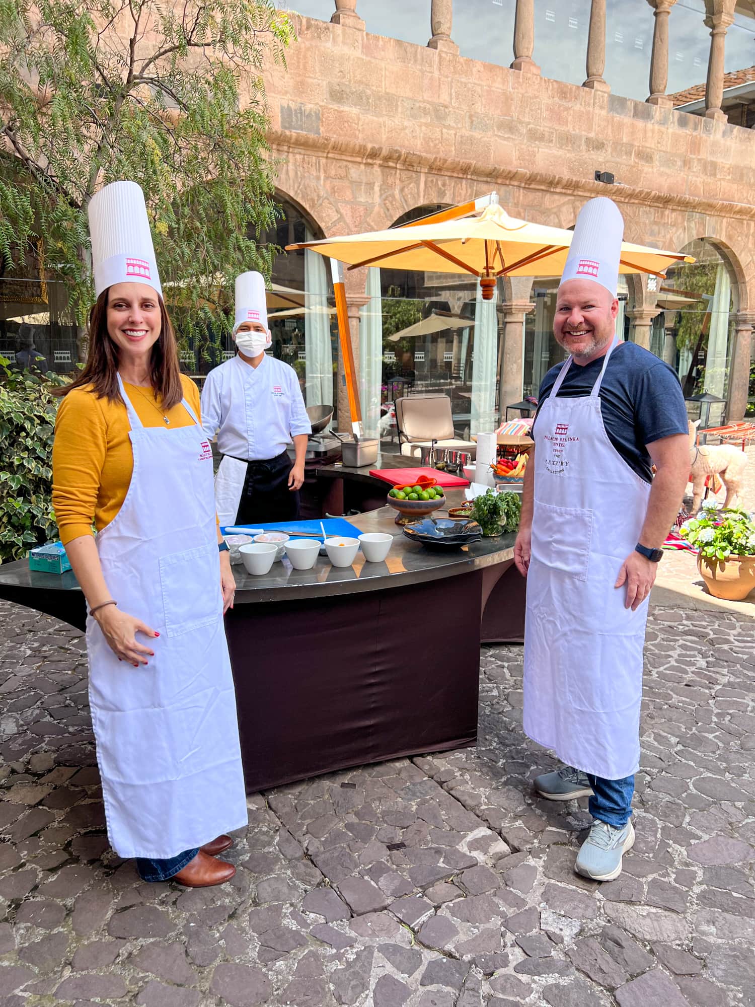 Kel and Dave dressed in chef's whites for a Peruvian cooking class