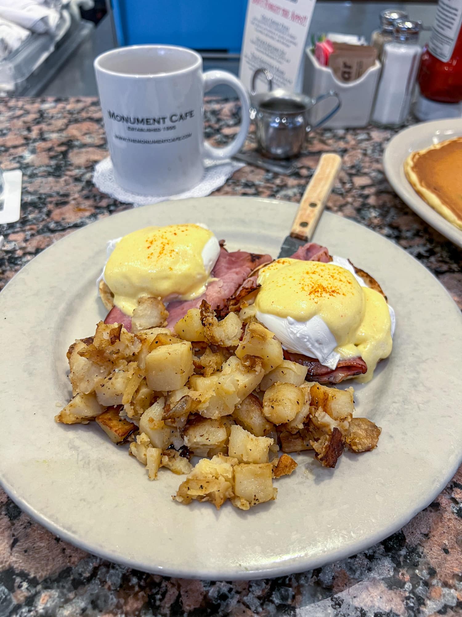 Eggs Benedict with potatoes at Monument Cafe