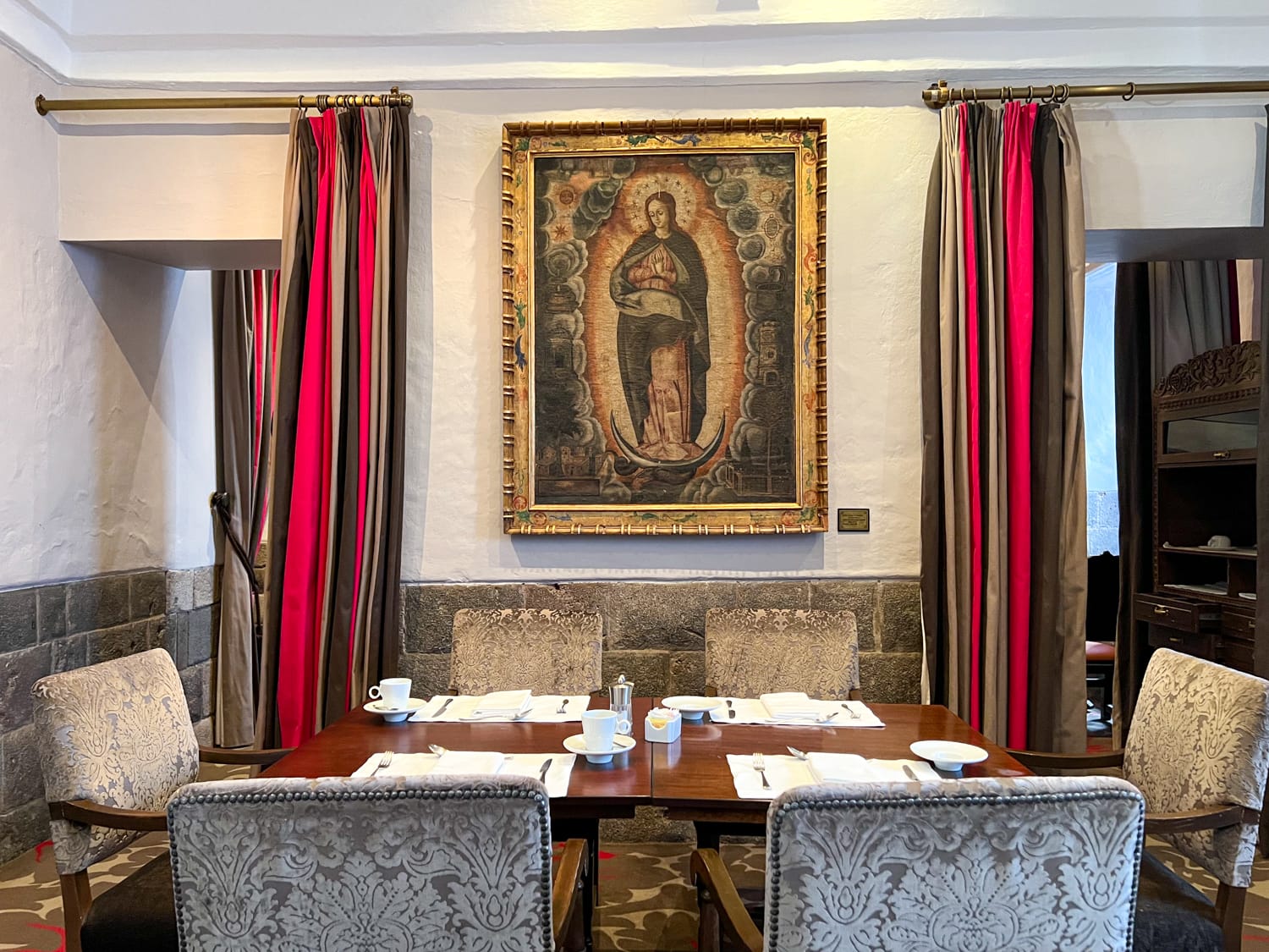 Religious painting and table in Inti Raymi Restaurant