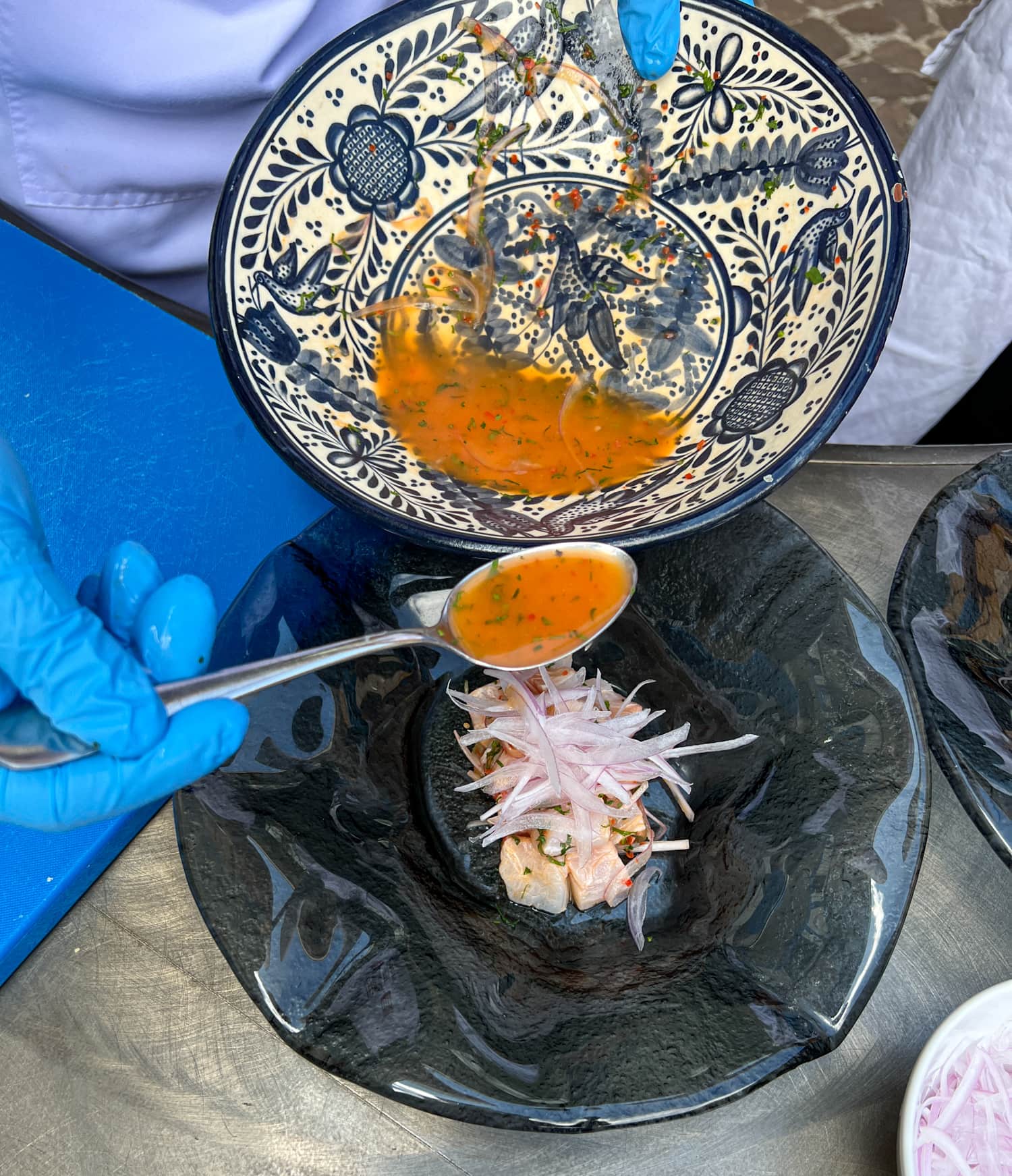 Adding leche de tigre sauce to the ceviche (photo by Kelly Lemons)