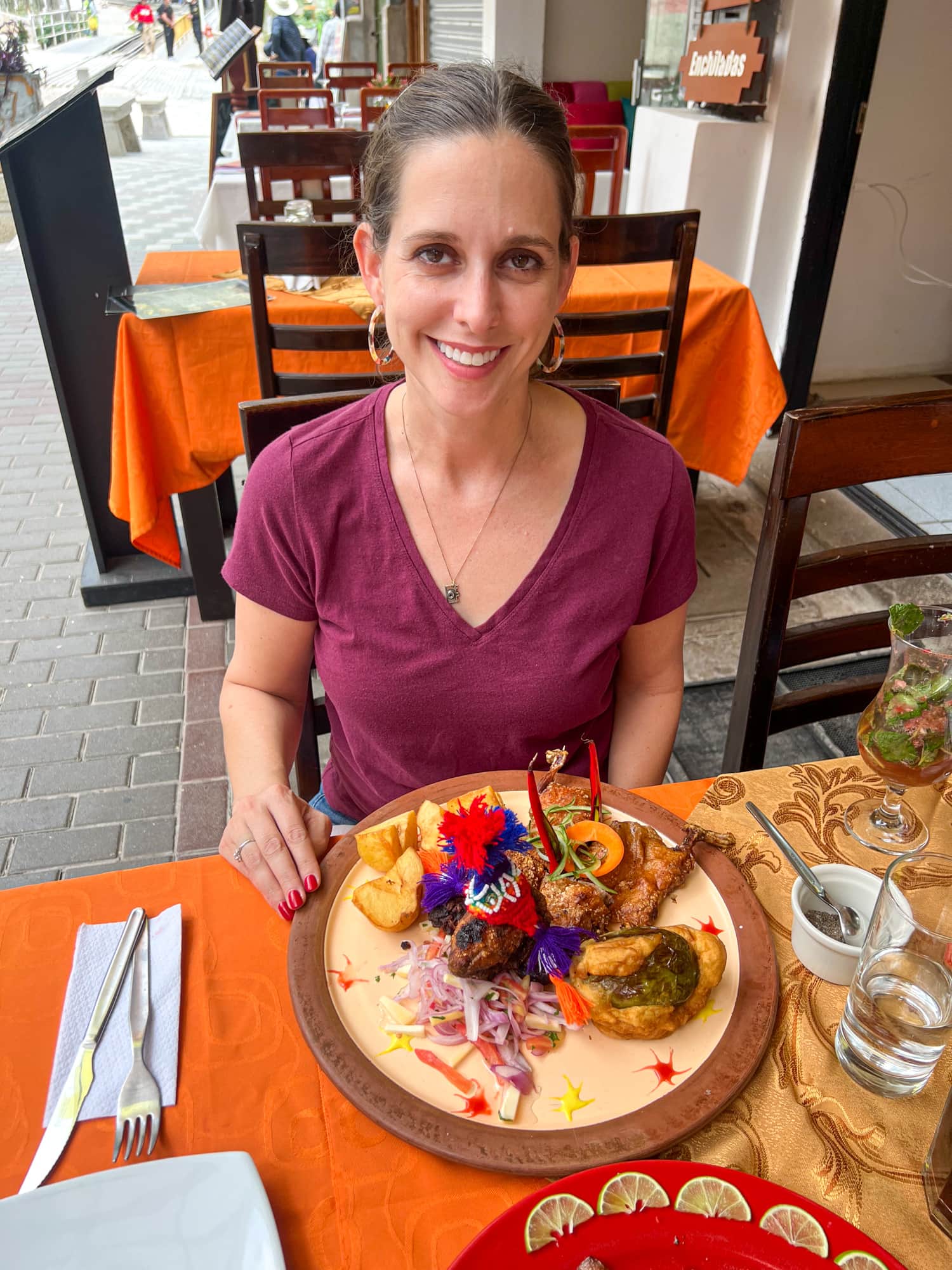 Kel with cuy chactado in Aguas Calientes, Peru