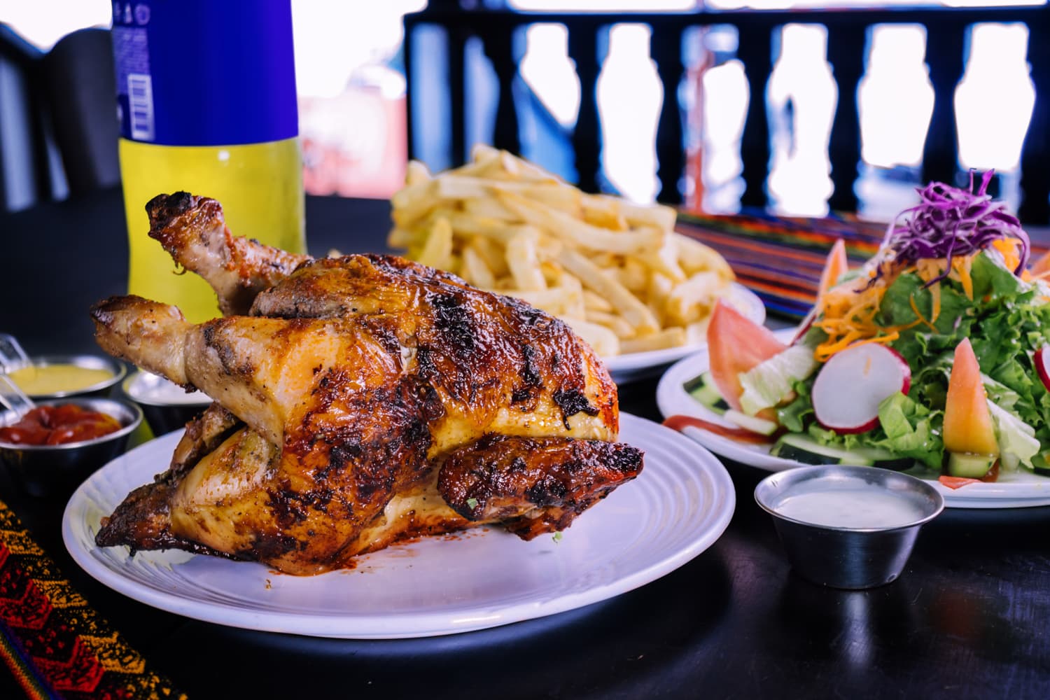 Peruvian chicken with French fries and Inka Cola (photo: Adobe Stock)