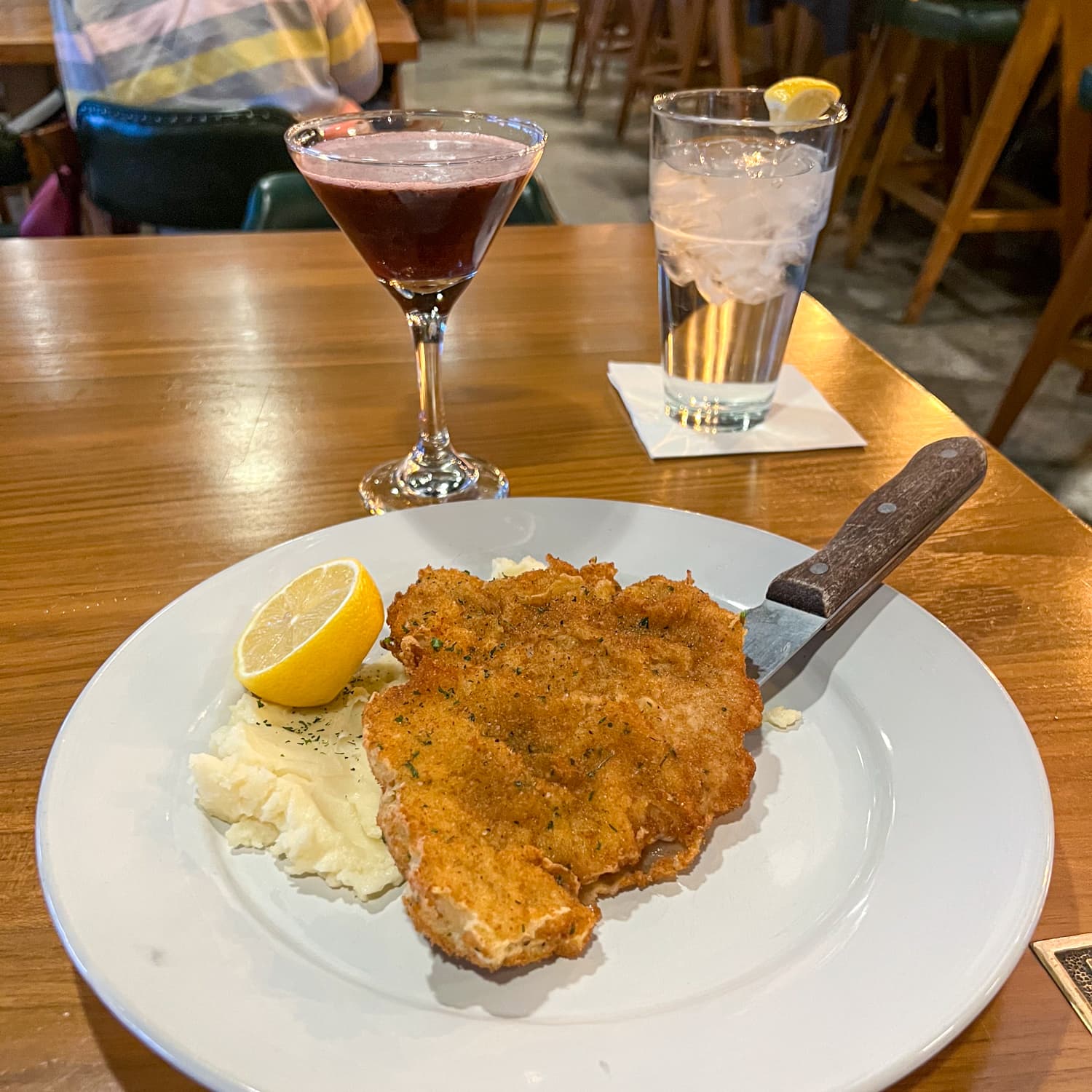 Czexan Schnitzel with mashed potatoes and a blackberry bramble cocktail at Pivovar, a Czech restaurant in Waco