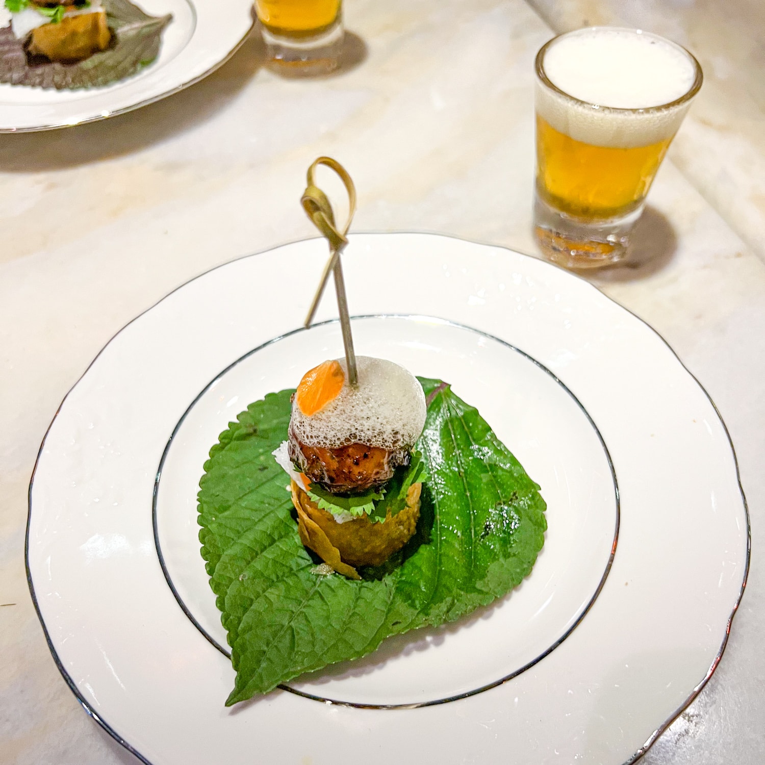 Bun cha Bourdain is served with a shot of beer