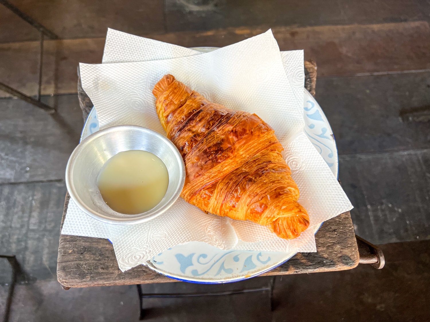 Fresh-baked croissant with sweetened condensed milk