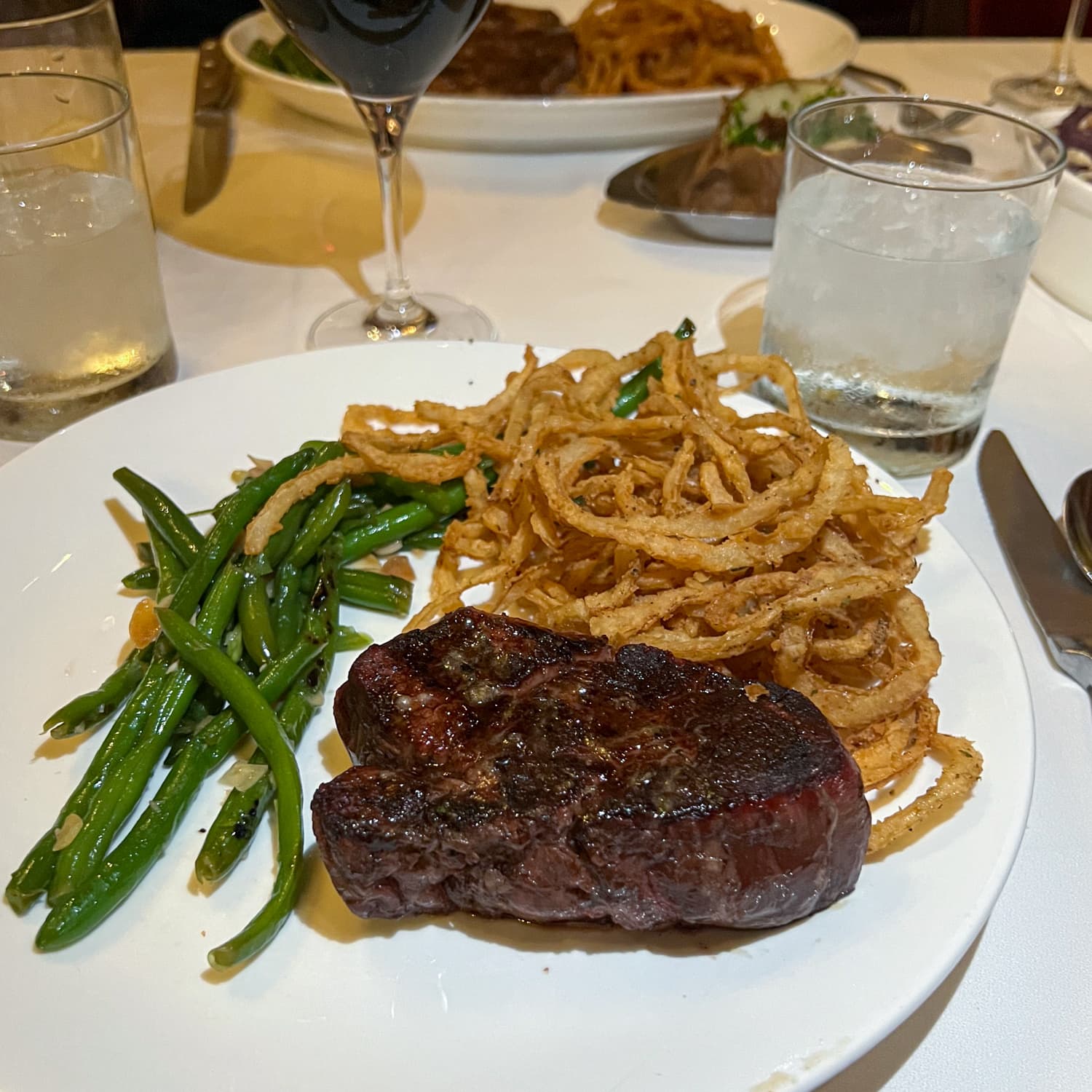 Filet mignon with string beans and onion rings at Bern's Steak House in Tampa