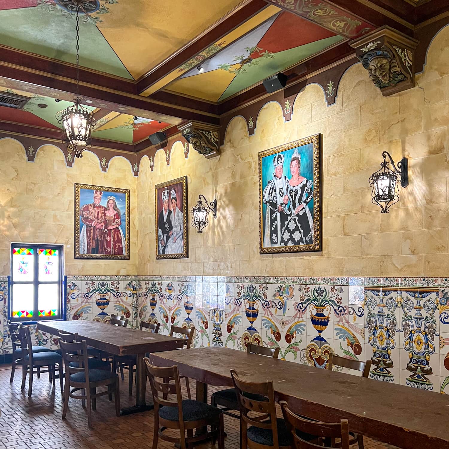 A painted ceiling and portraits adorn this dining room